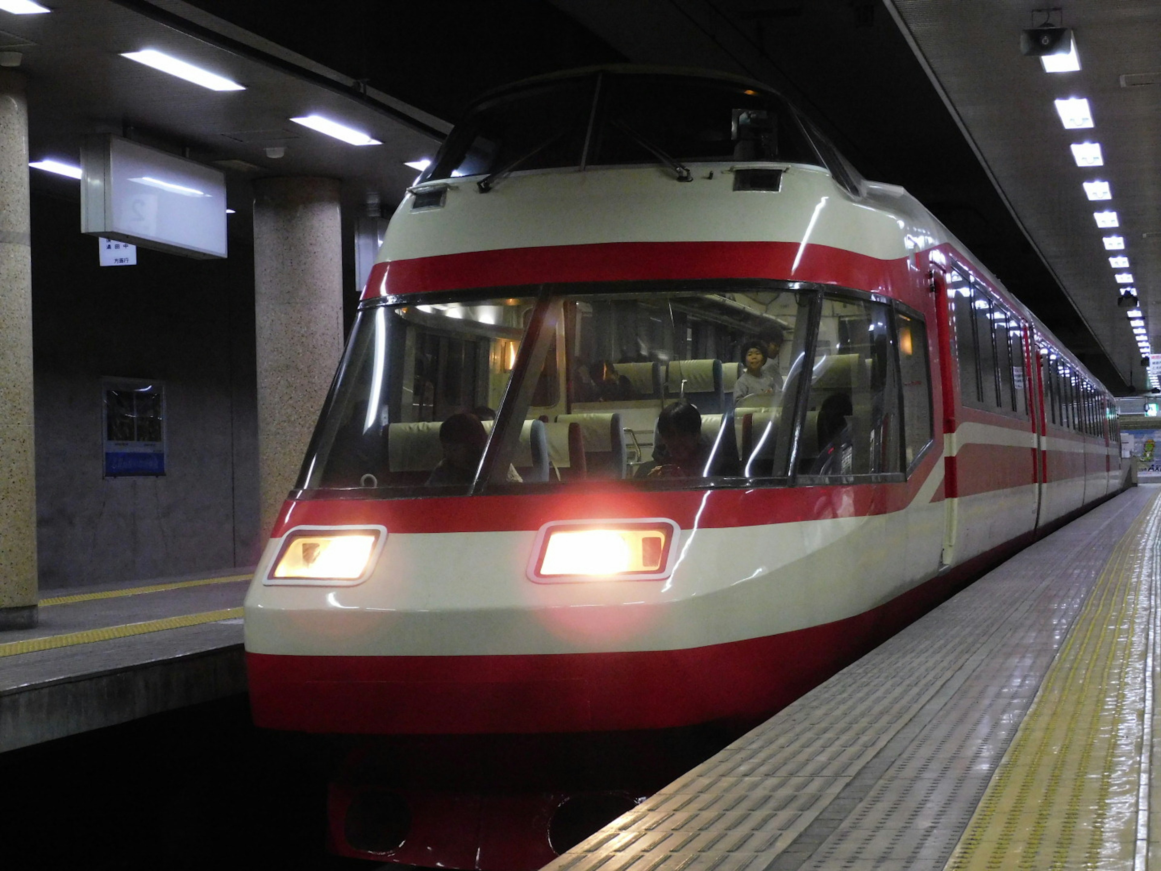 Red and white train stationed at a subway platform