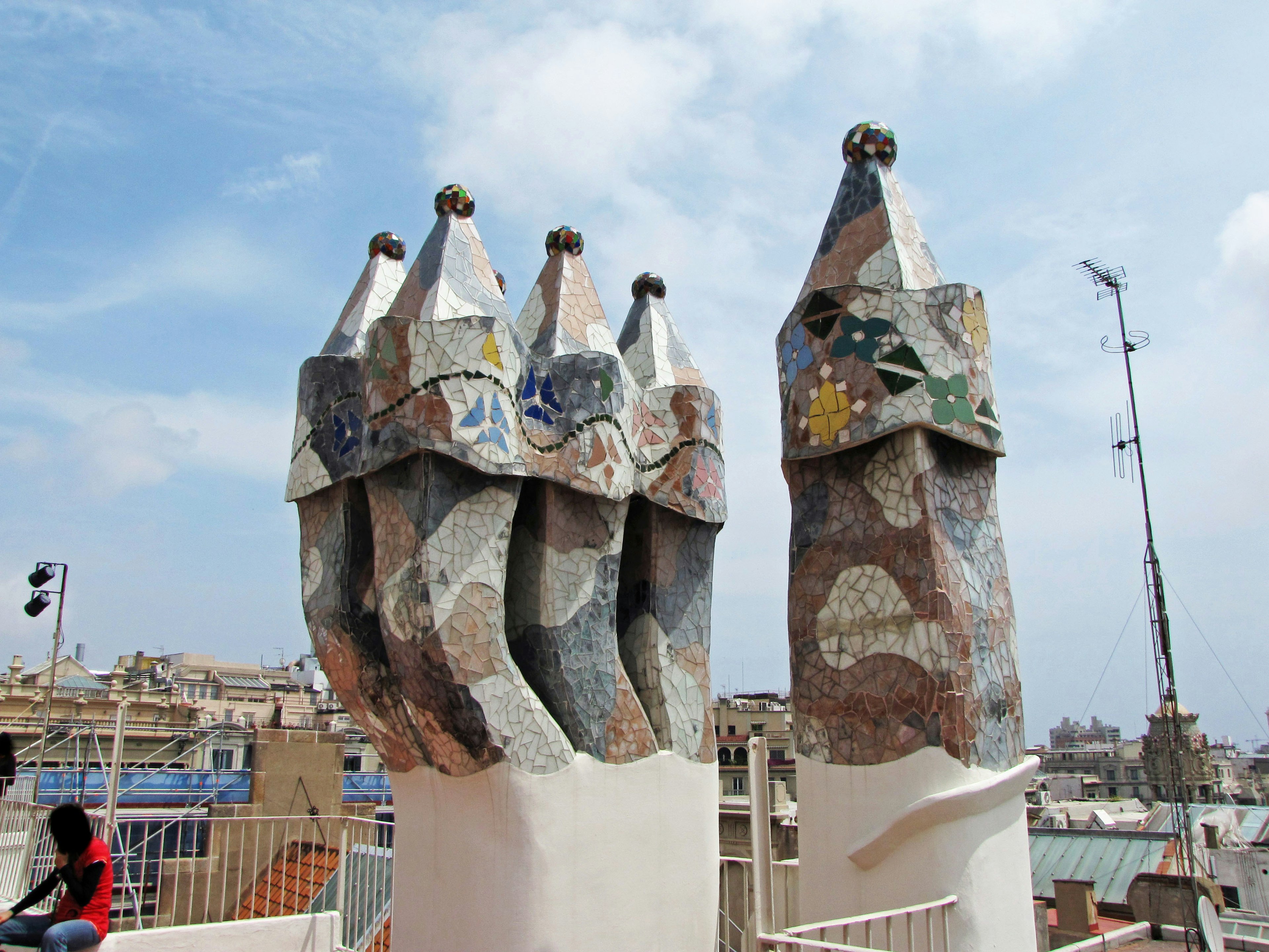 Unique chimney designs of Casa Mila in Barcelona featuring colorful mosaics