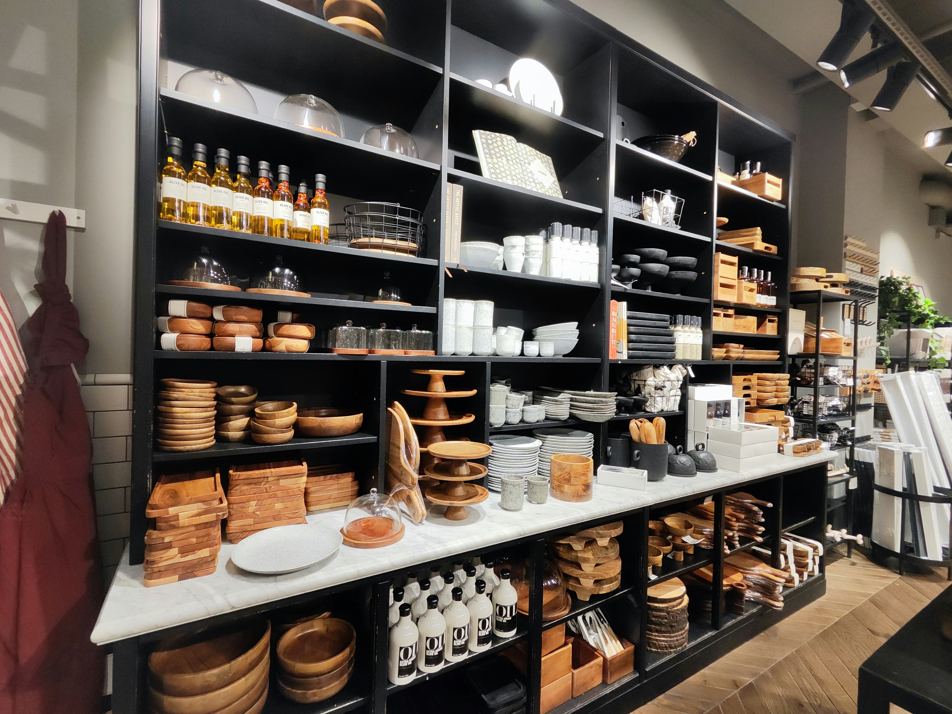 Organized shelves displaying wooden utensils and kitchenware