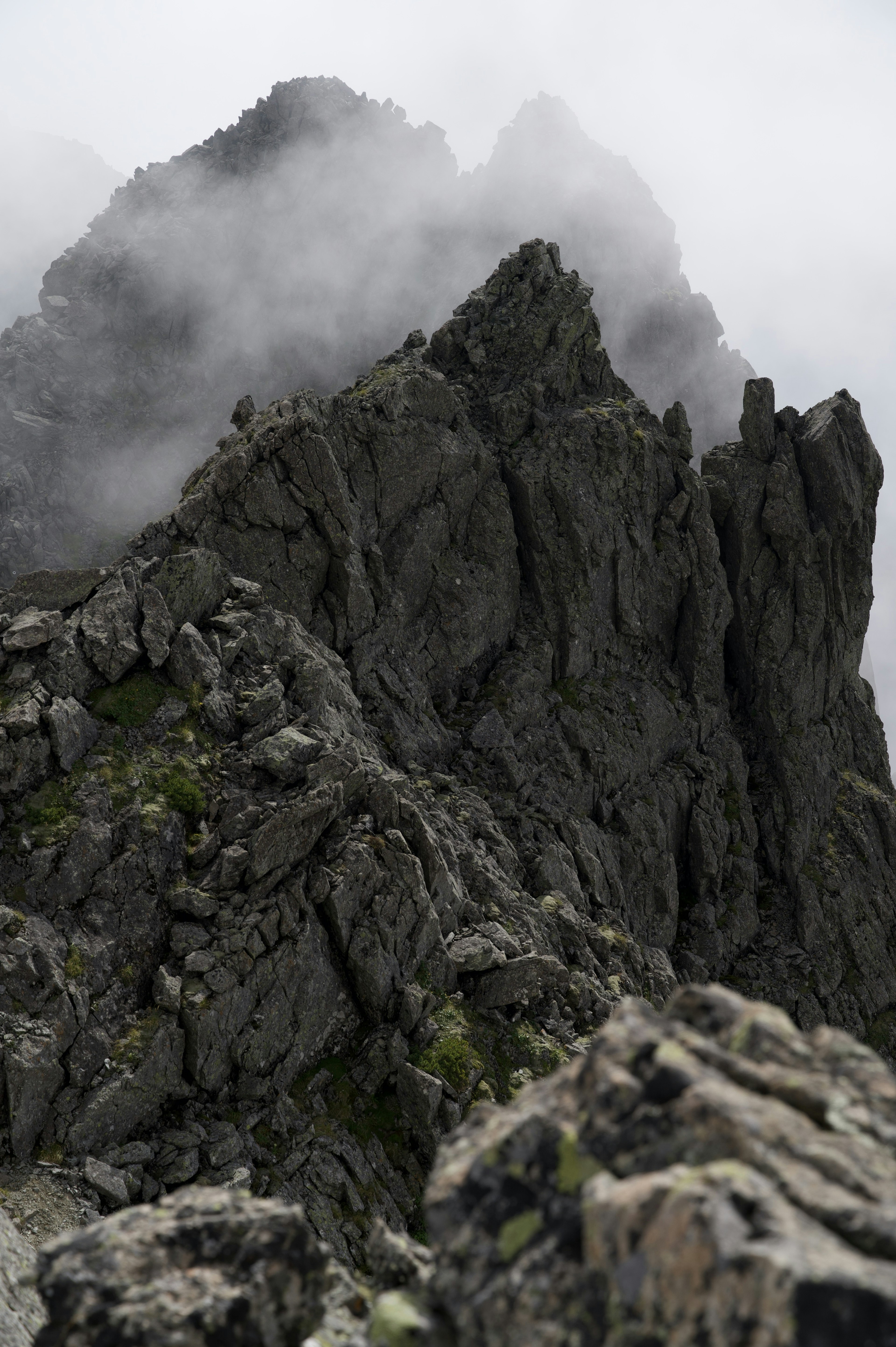 Jagged mountain peaks shrouded in mist