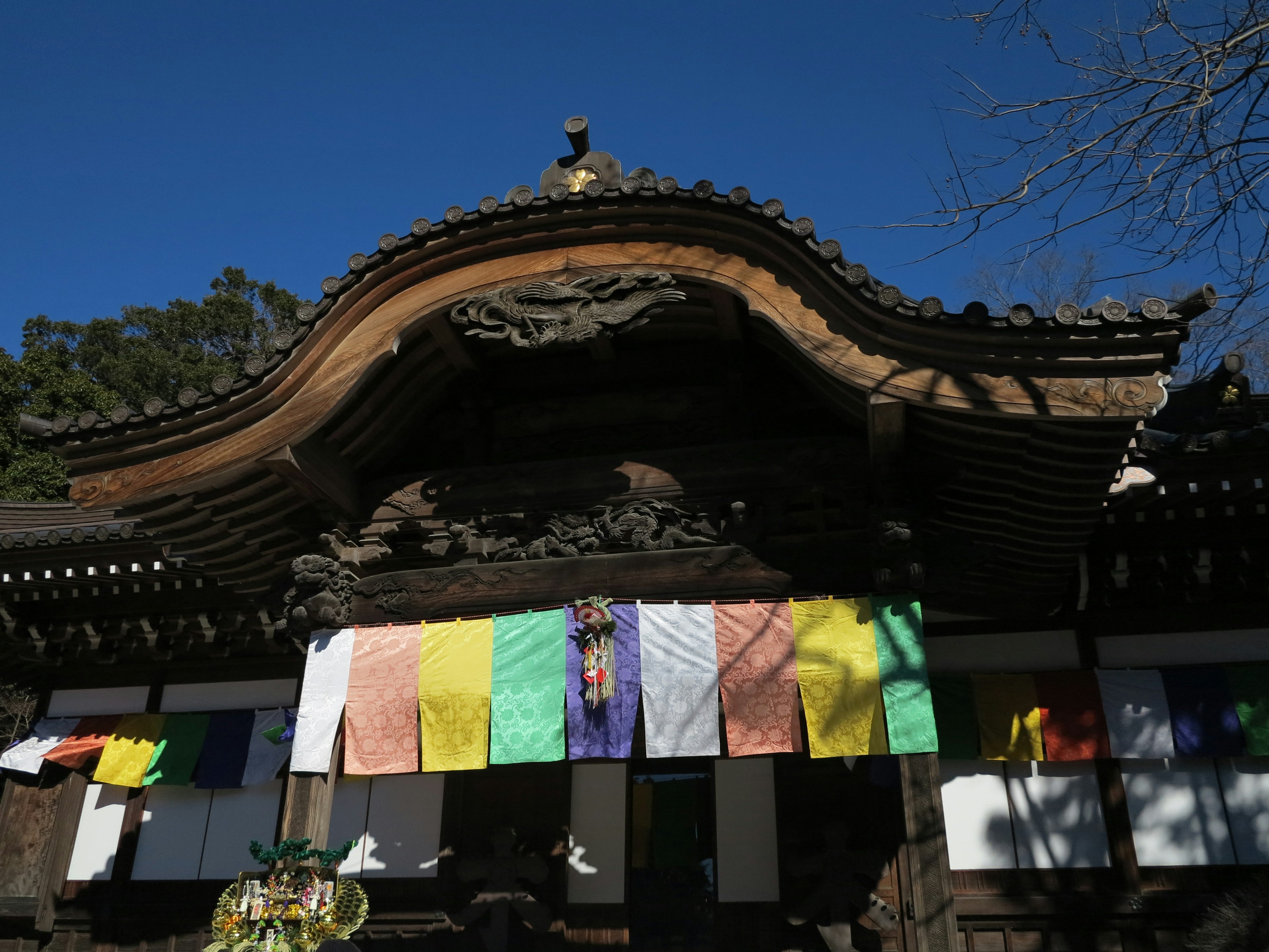 Traditional Japanese temple building adorned with colorful flags