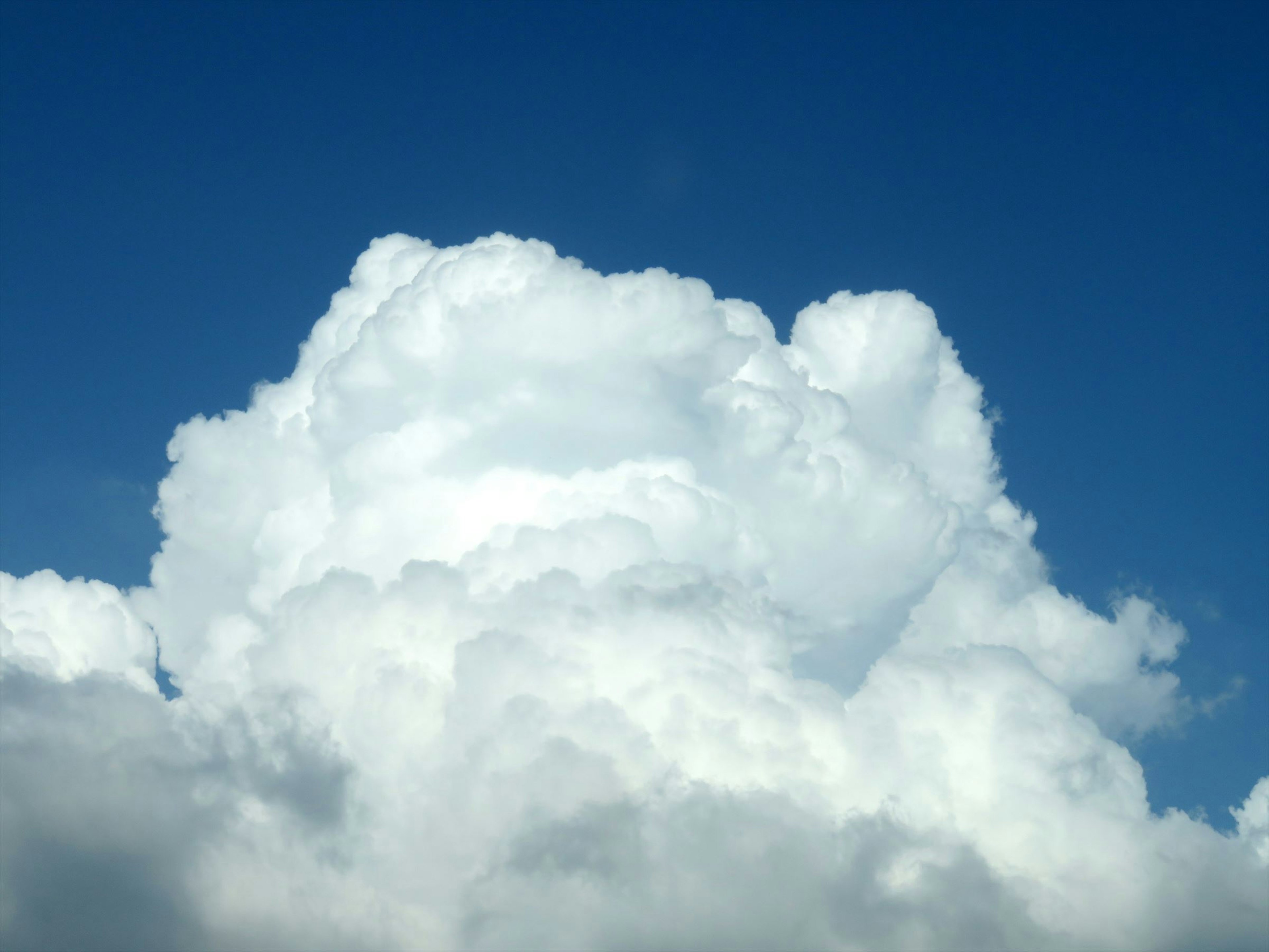 Fluffy white clouds against a blue sky