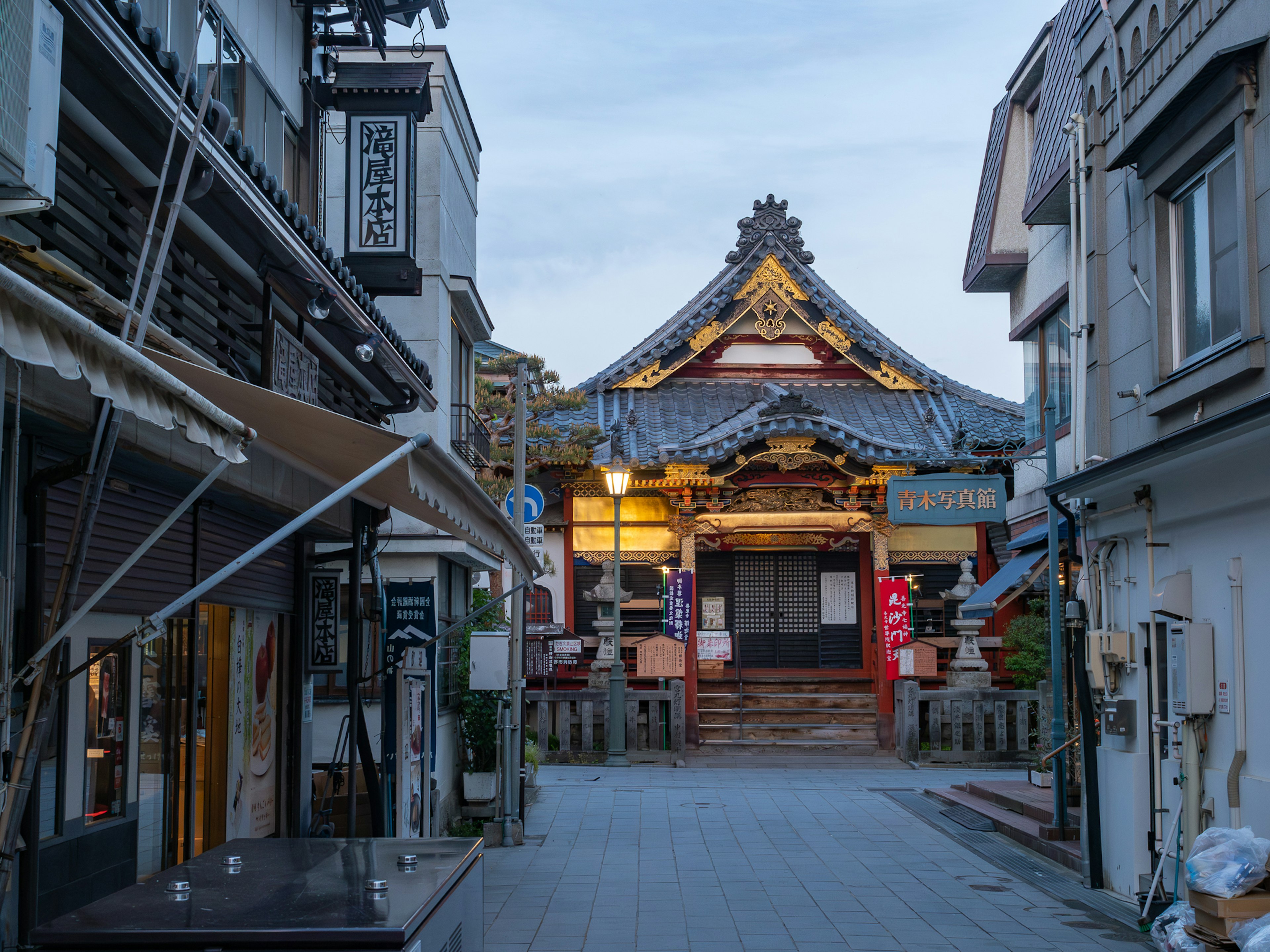 Beautiful shrine building facing a quiet street with surrounding shops