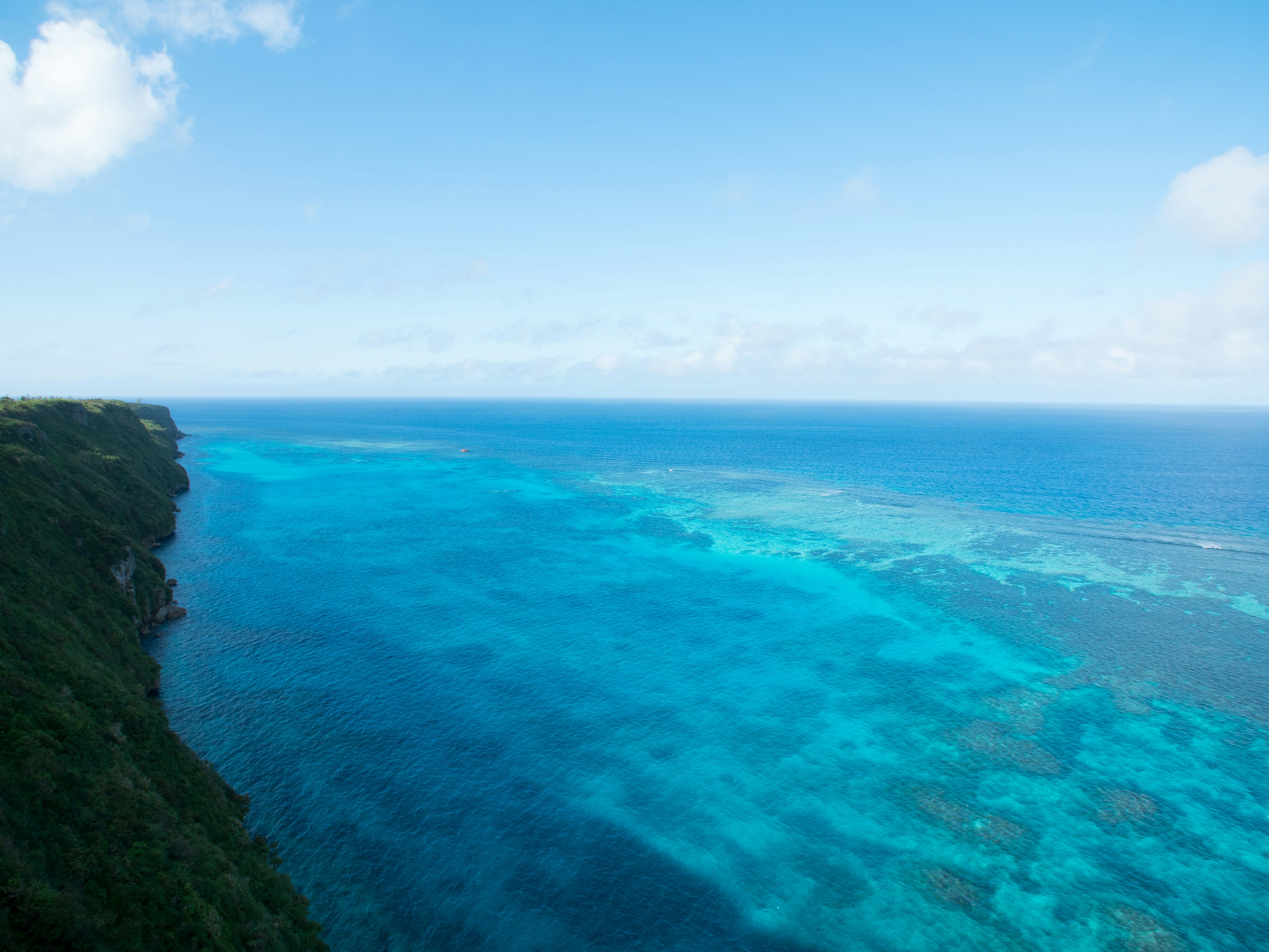 Vibrant blue ocean with visible coral reefs