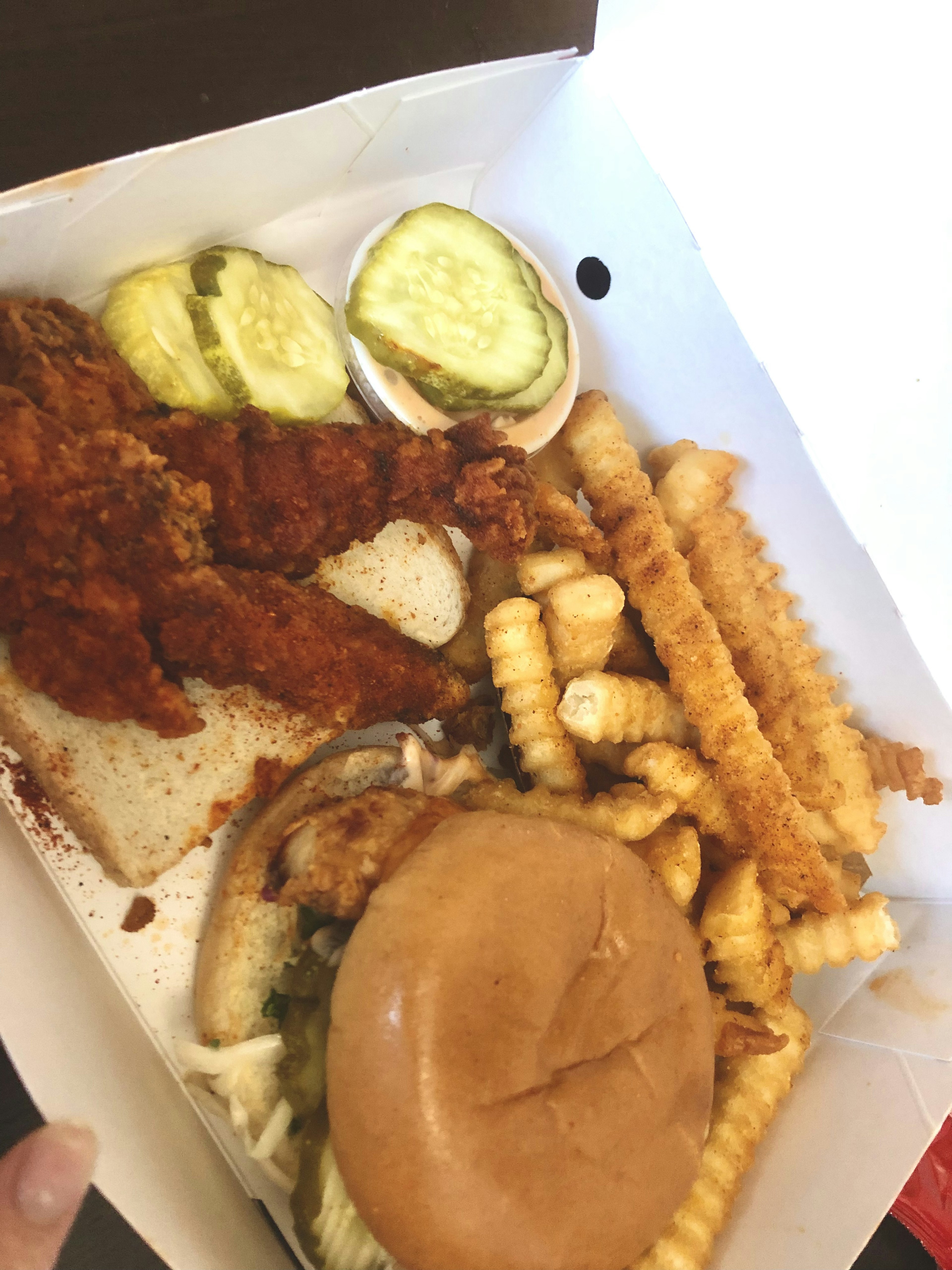 Takeout box with fried chicken and a hamburger