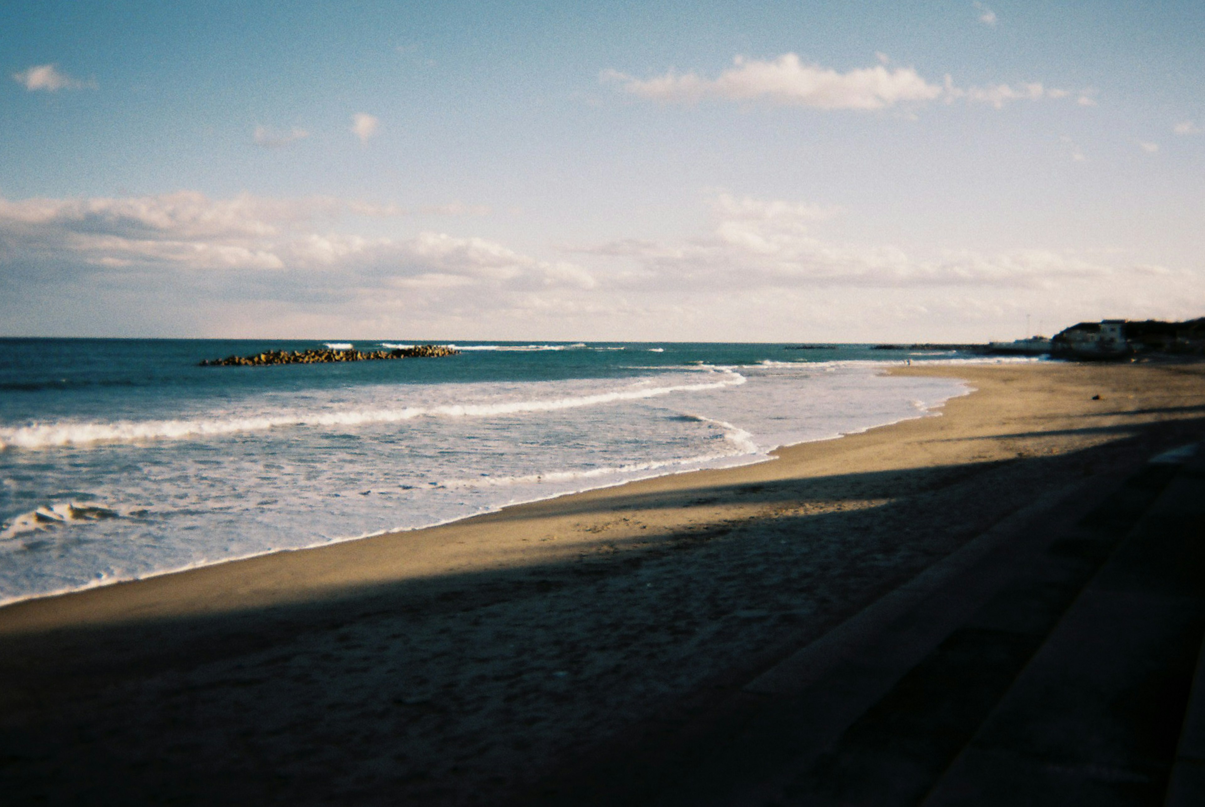 Serene beach landscape with calm sea and blue sky