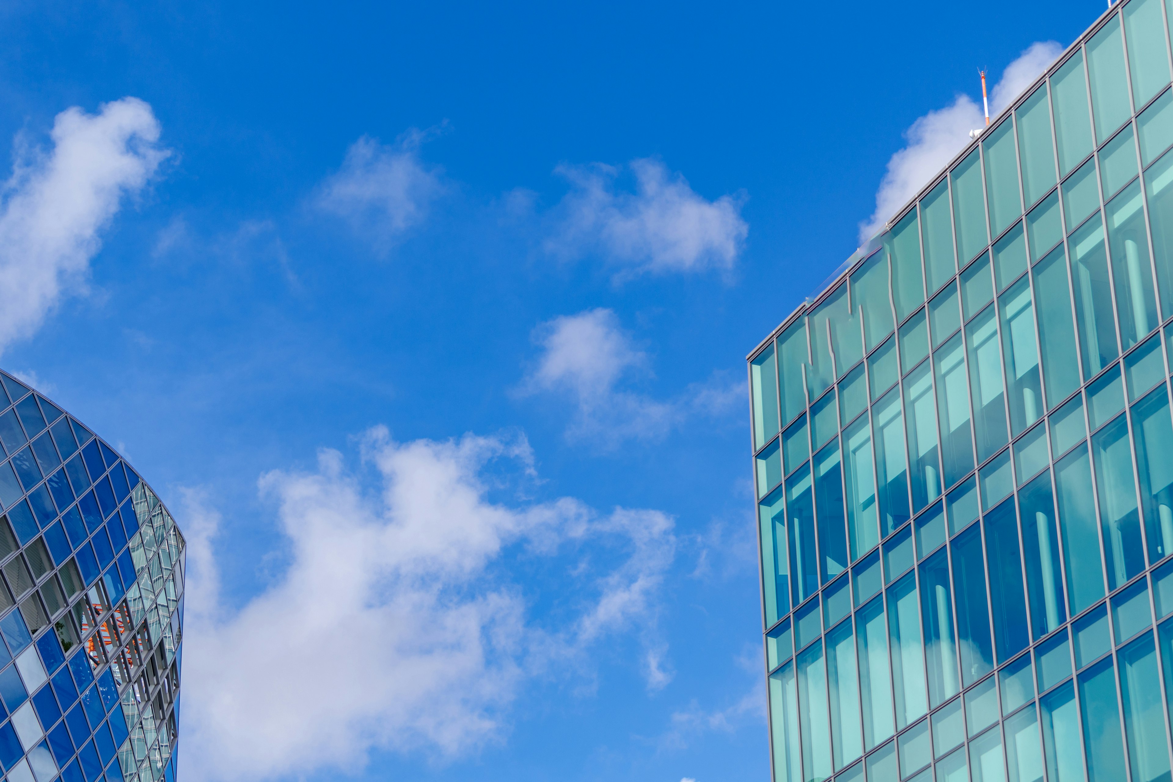 Modern building facades under a blue sky