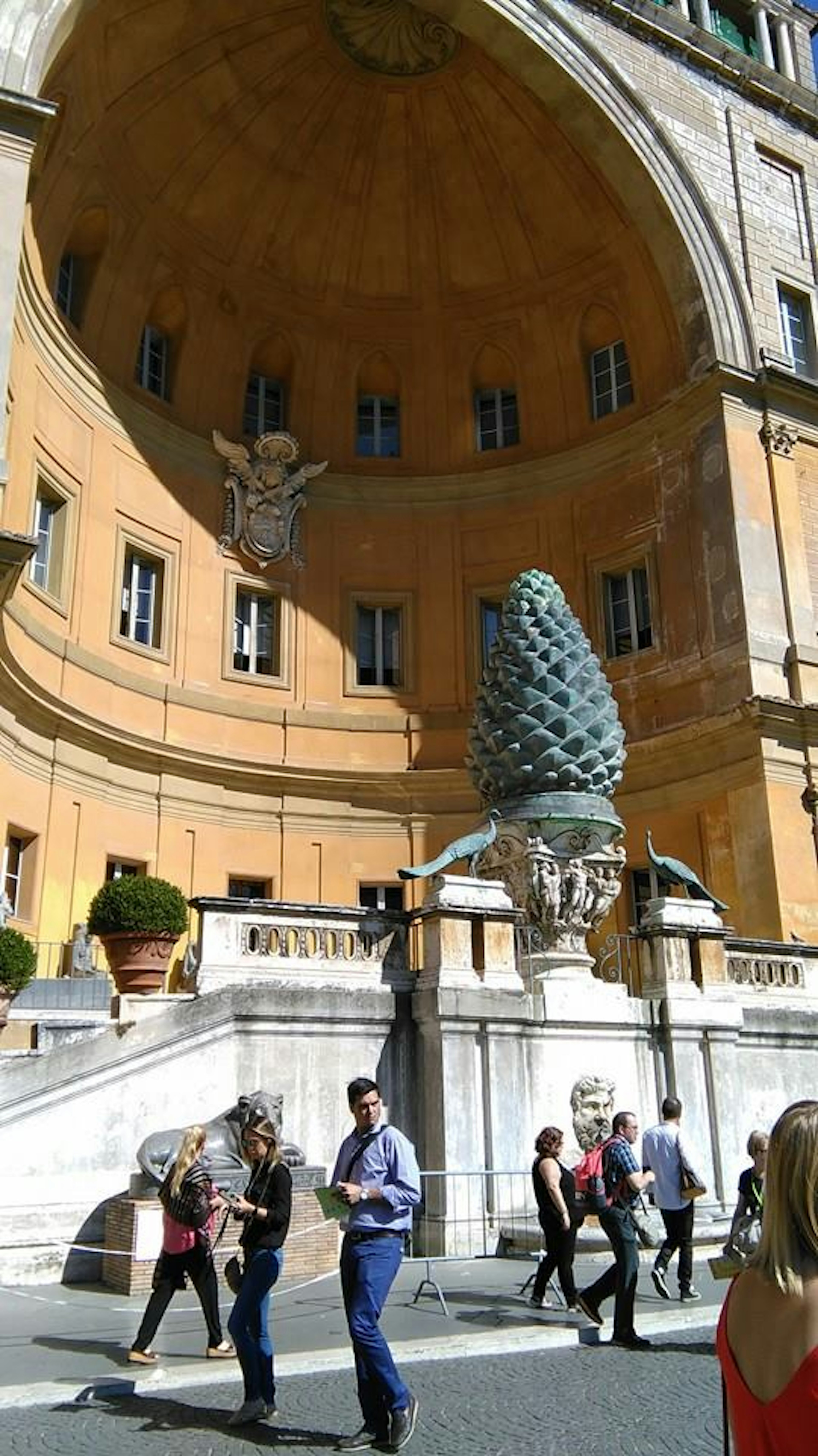 Large pine cone sculpture and historical architecture in Vatican City