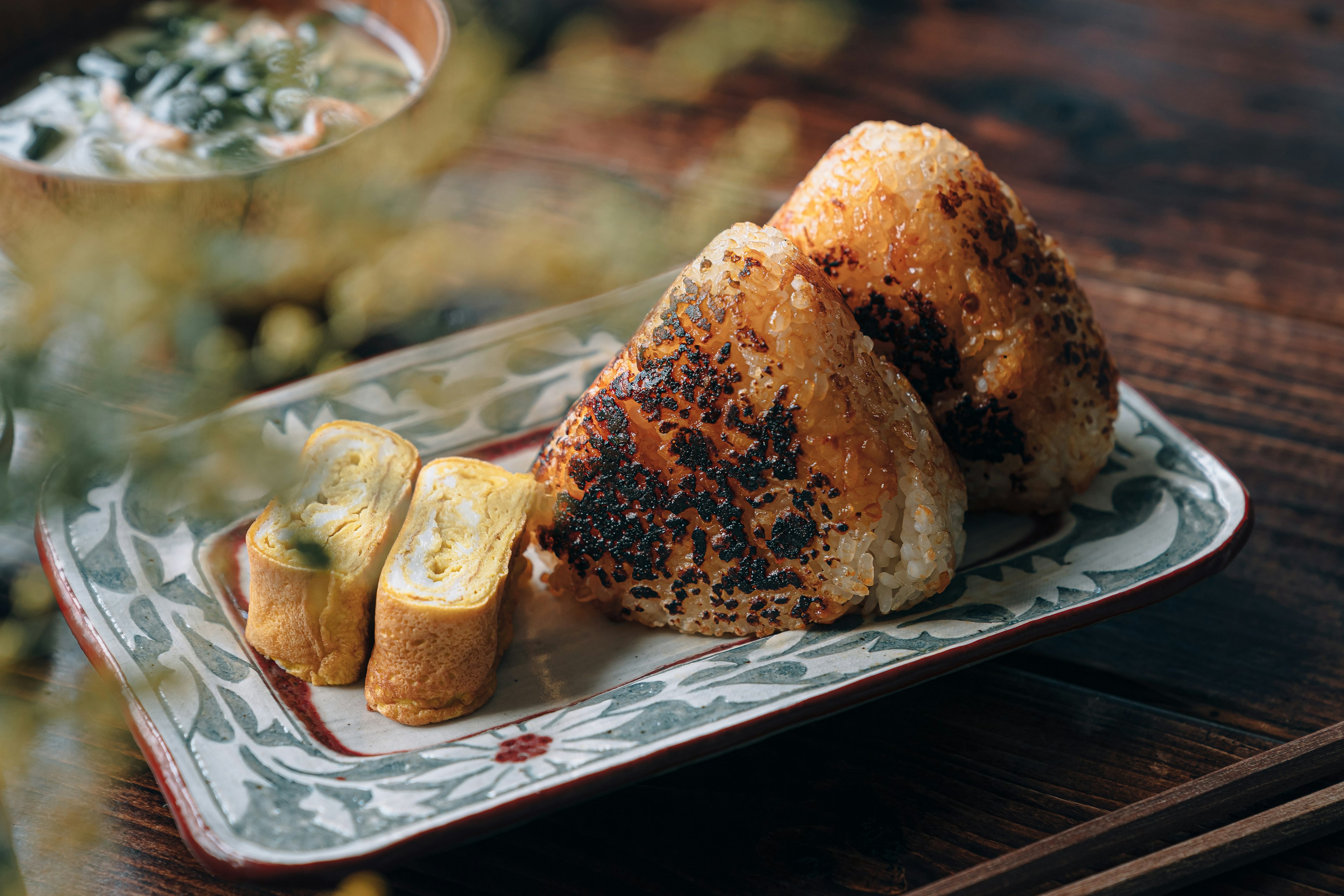 Image of grilled rice balls and rolled omelette on a decorative plate