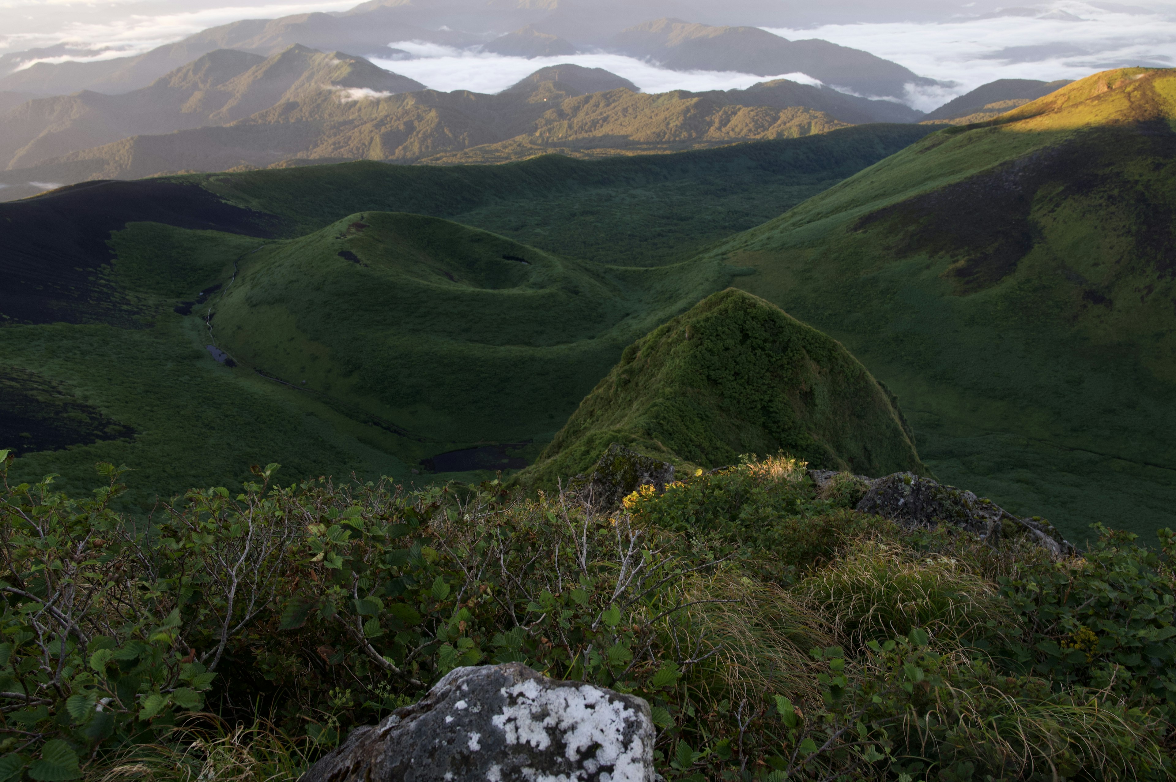 Landscape showing green hills and distant mountains