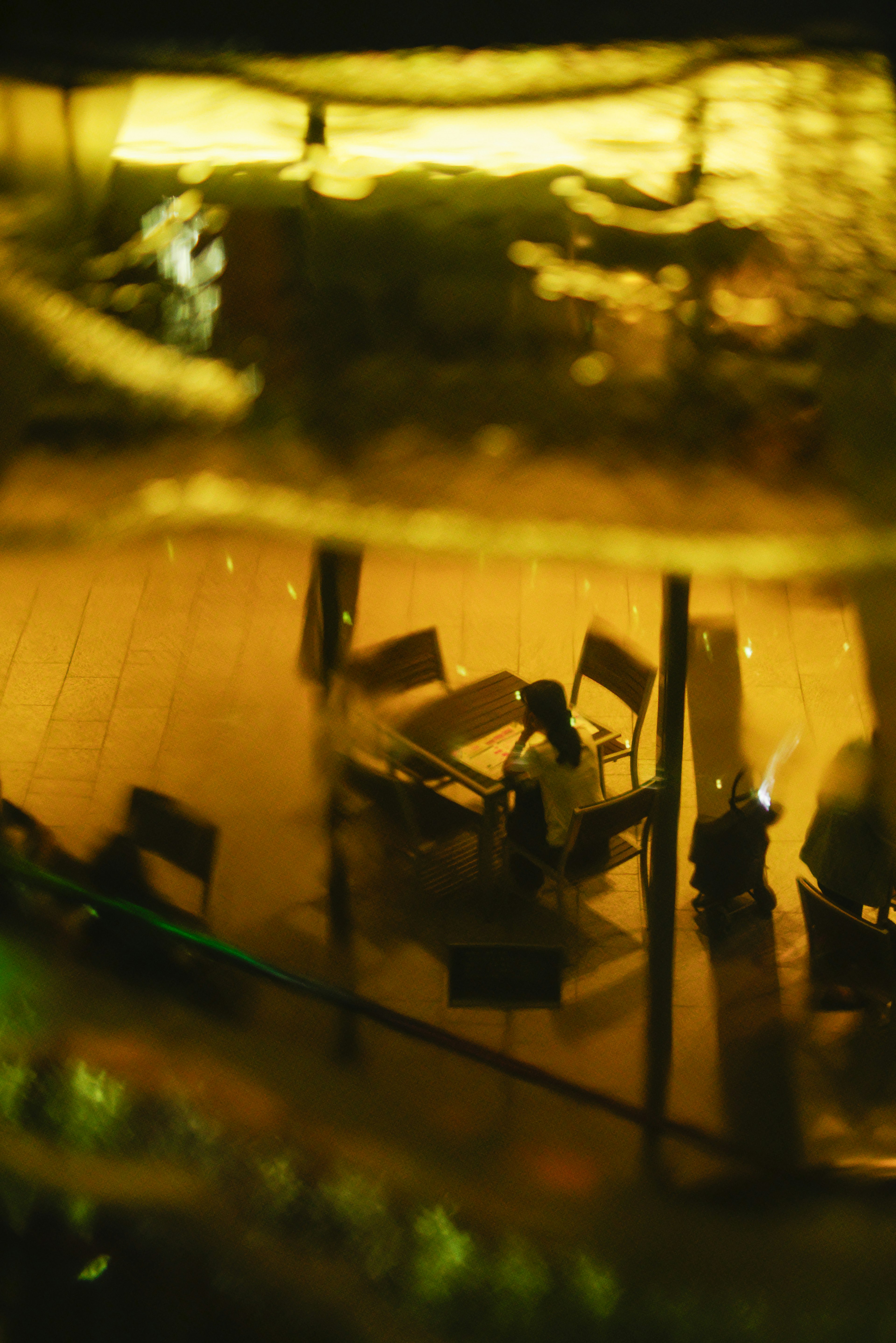 View of café tables and chairs seen from below water