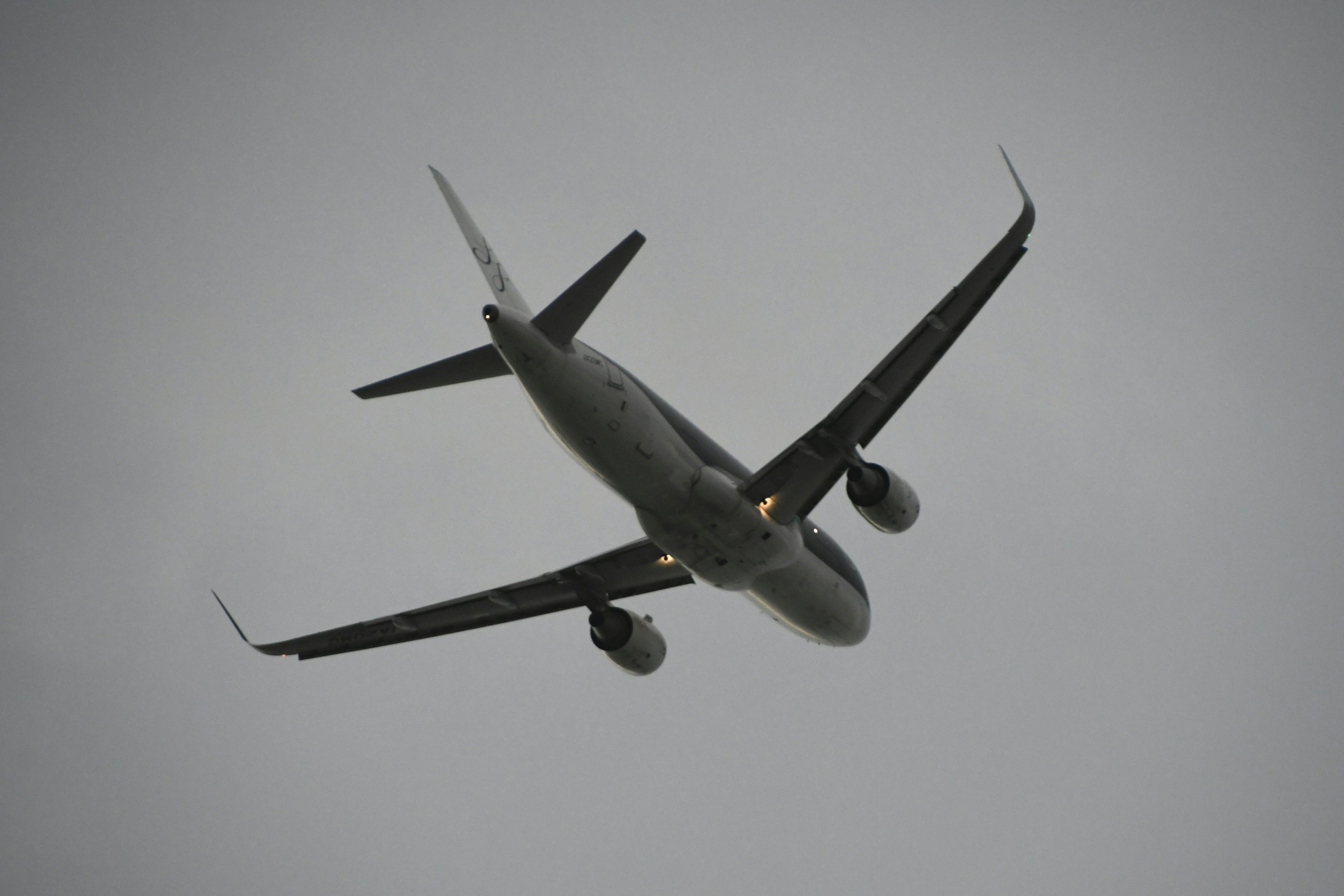 Airplane flying through clouds from a diagonal upward angle