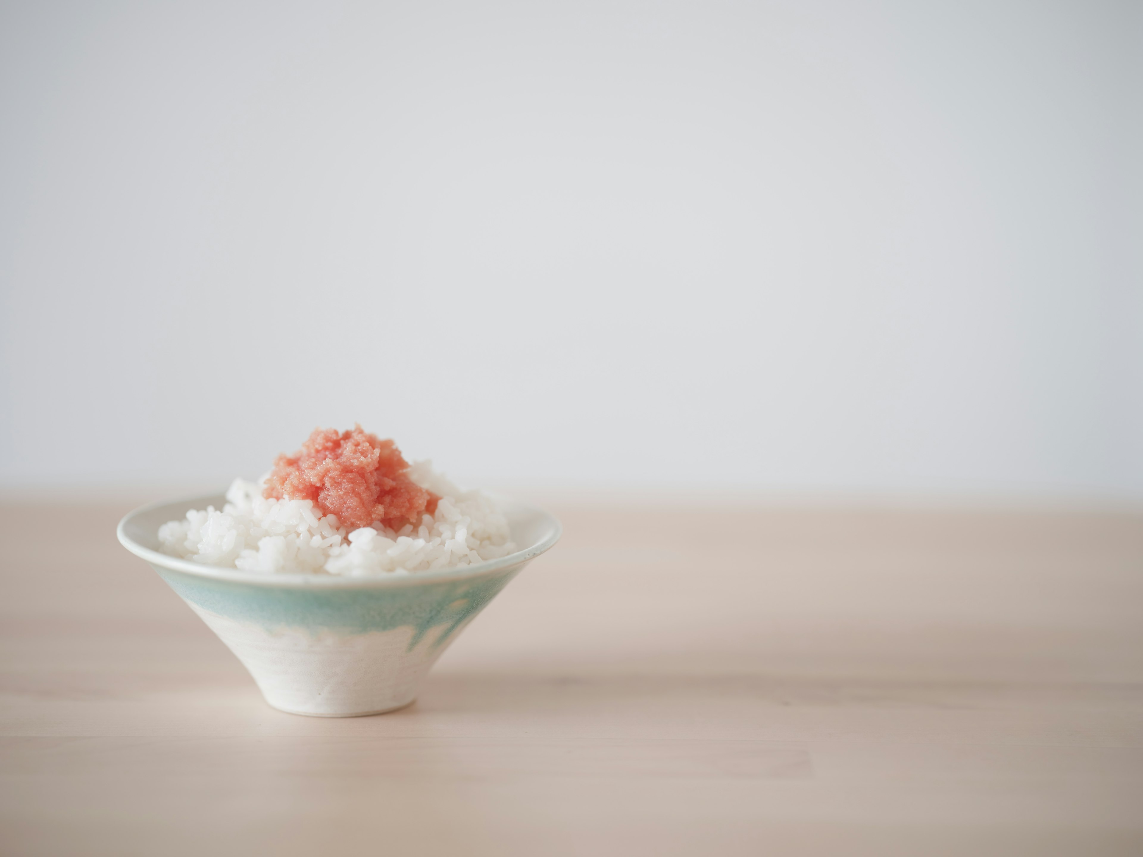 Bowl of white rice topped with salmon flakes