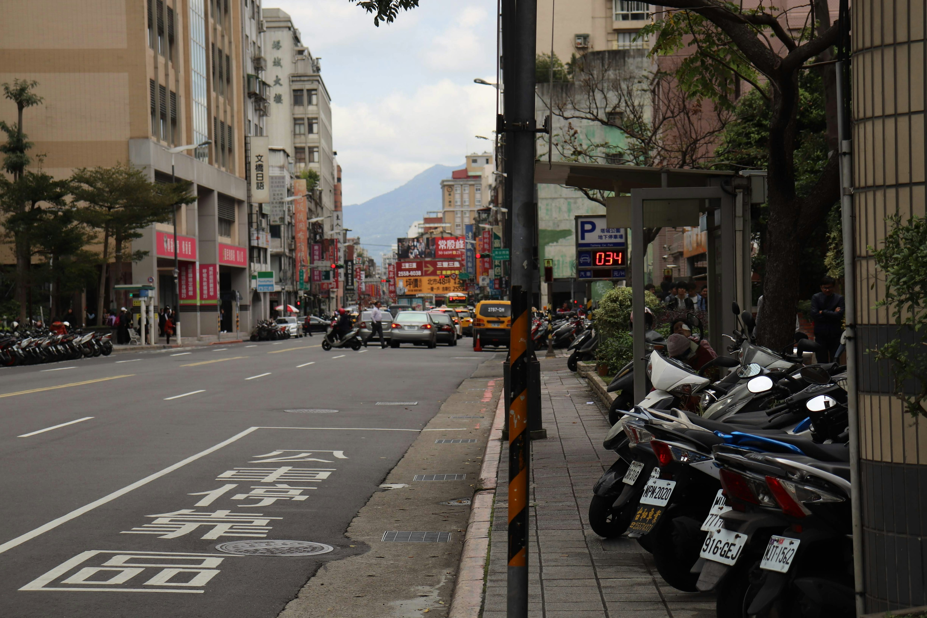 Pemandangan jalan di Taipei dengan sepeda motor terparkir dan gedung