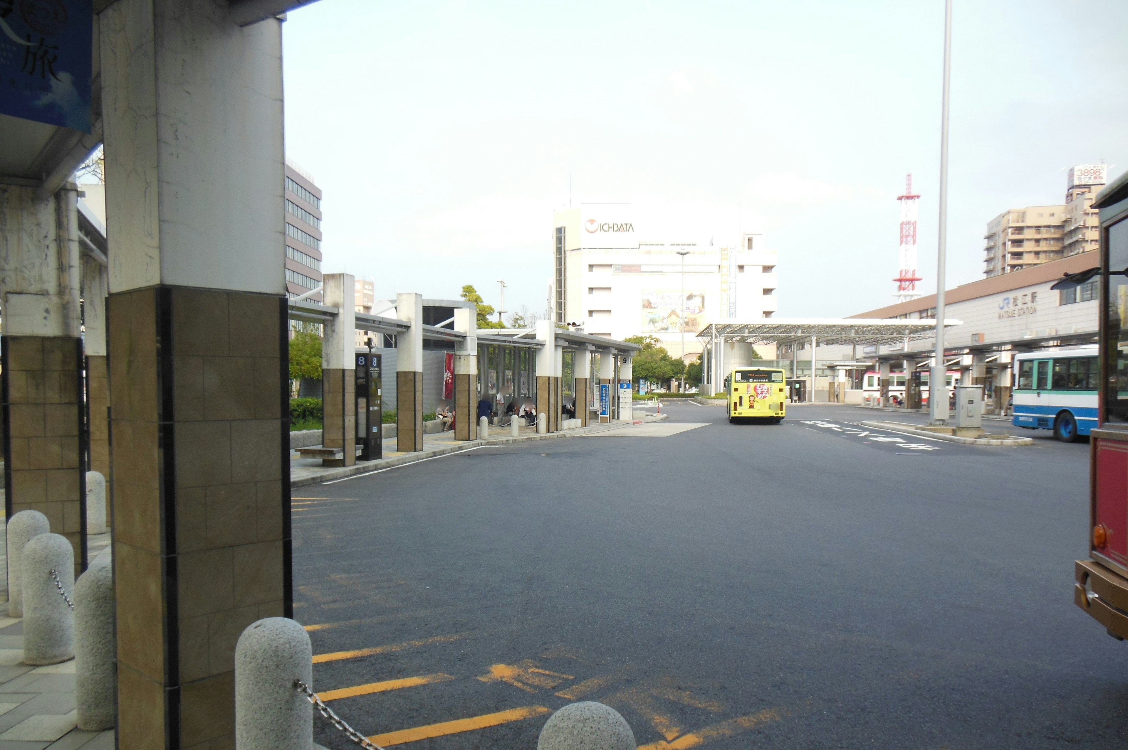 Urban scene with empty bus stops and wide road