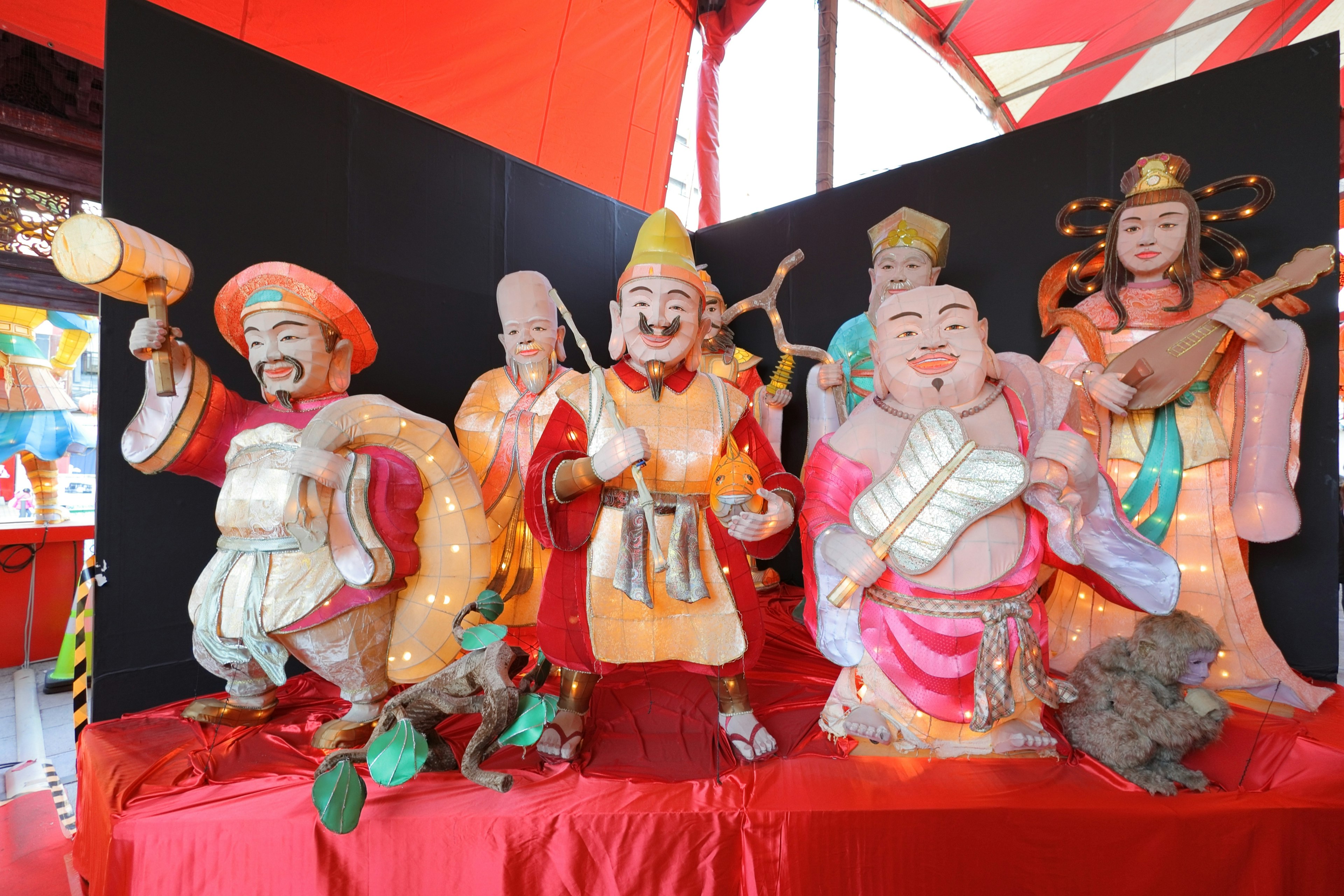 Colorful display of five traditional figurines representing deities