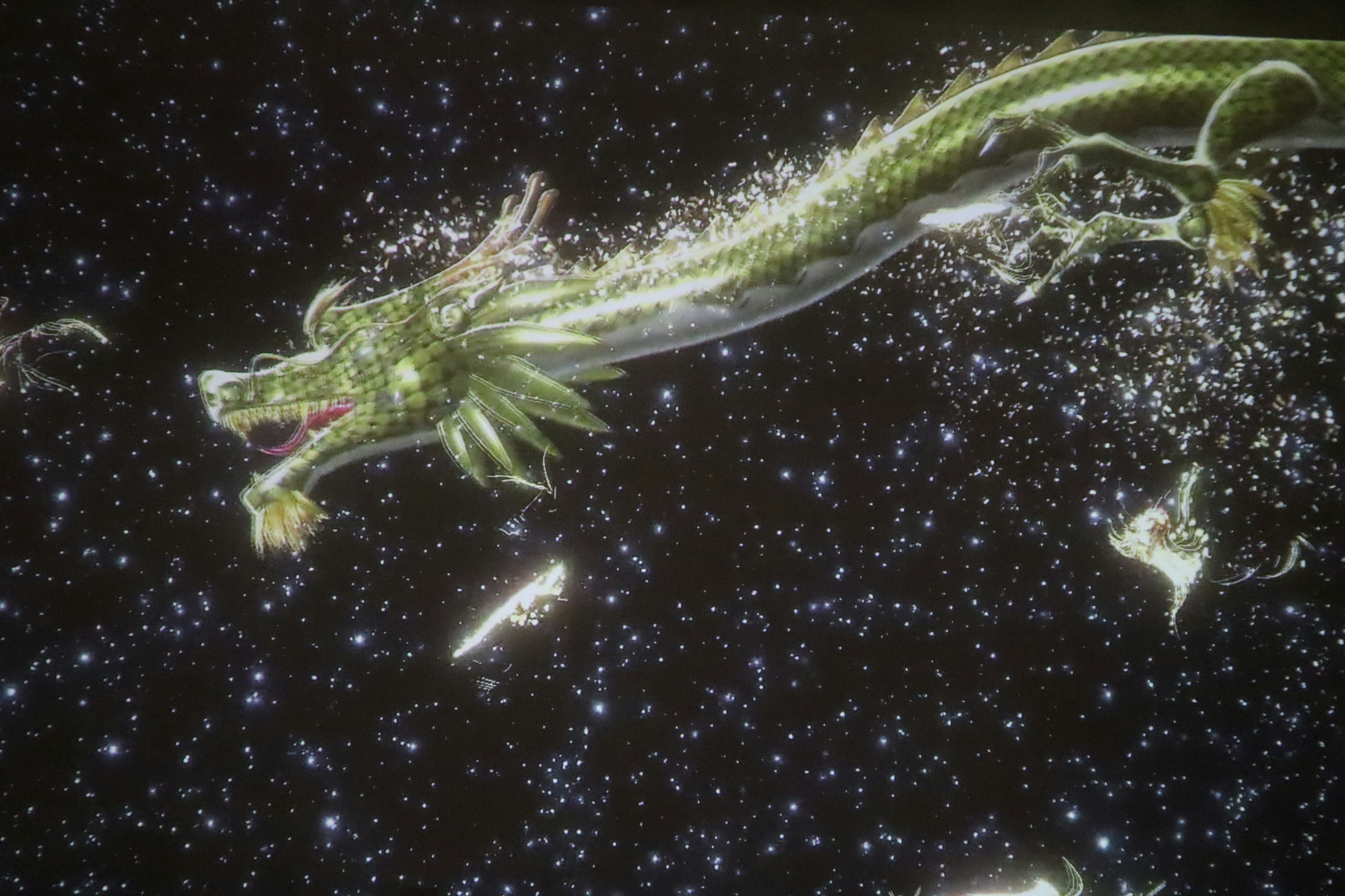 A green dragon flying through space with a starry background