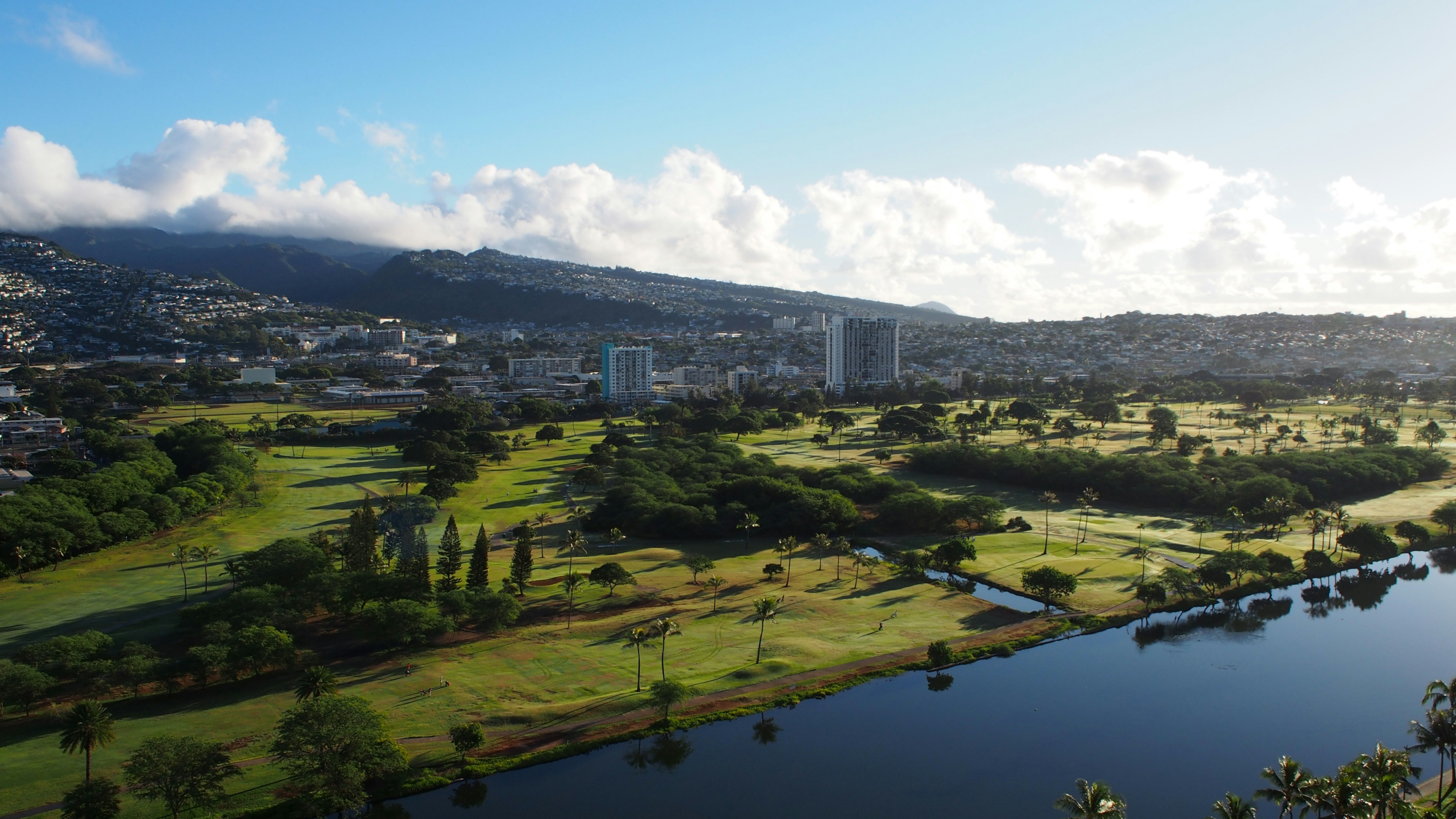 Pemandangan panorama dari lanskap yang indah dengan lapangan golf yang subur dan sungai yang tenang