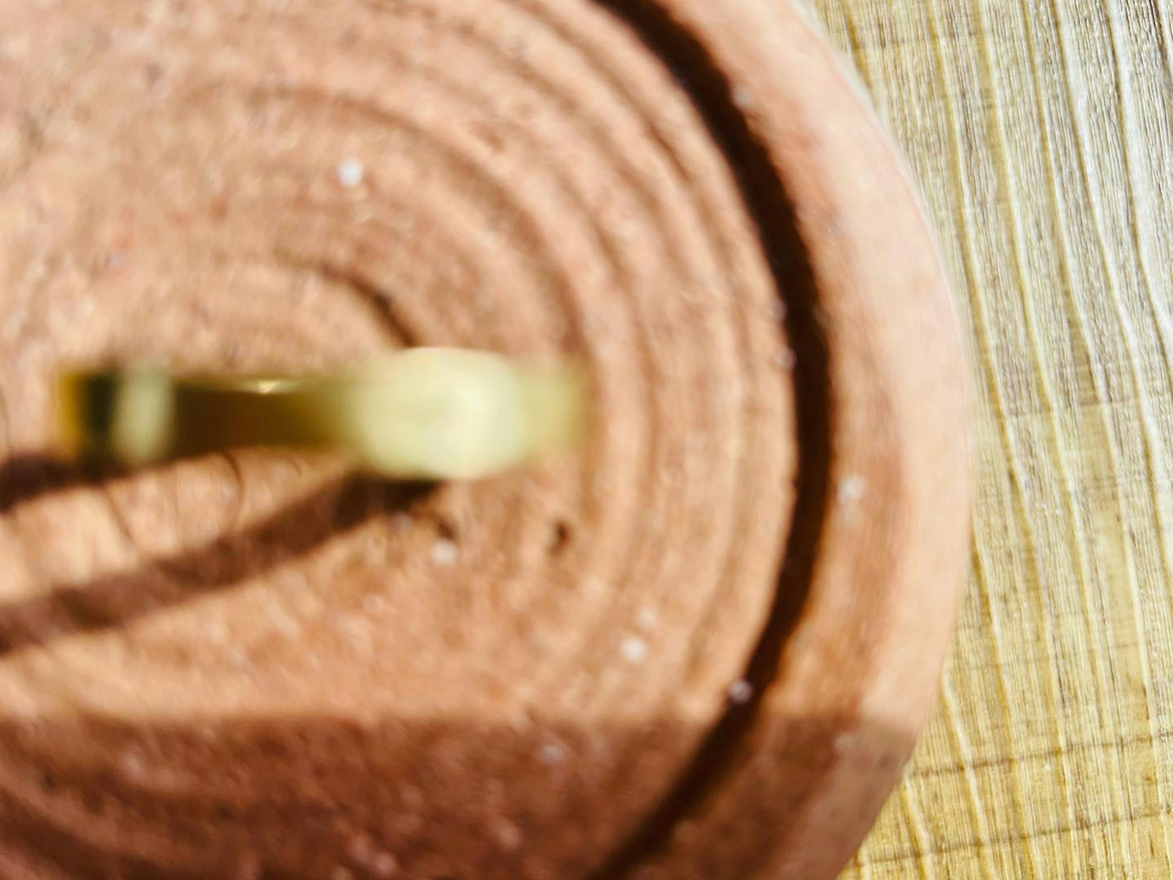 Close-up of a brown circular candle with a wick