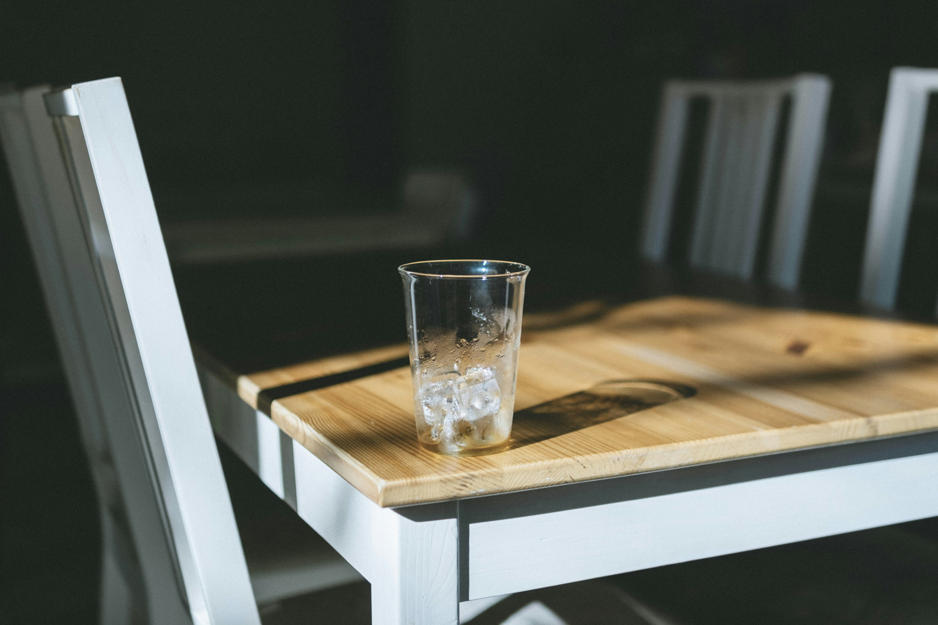 Transparent glass with ice on a wooden table