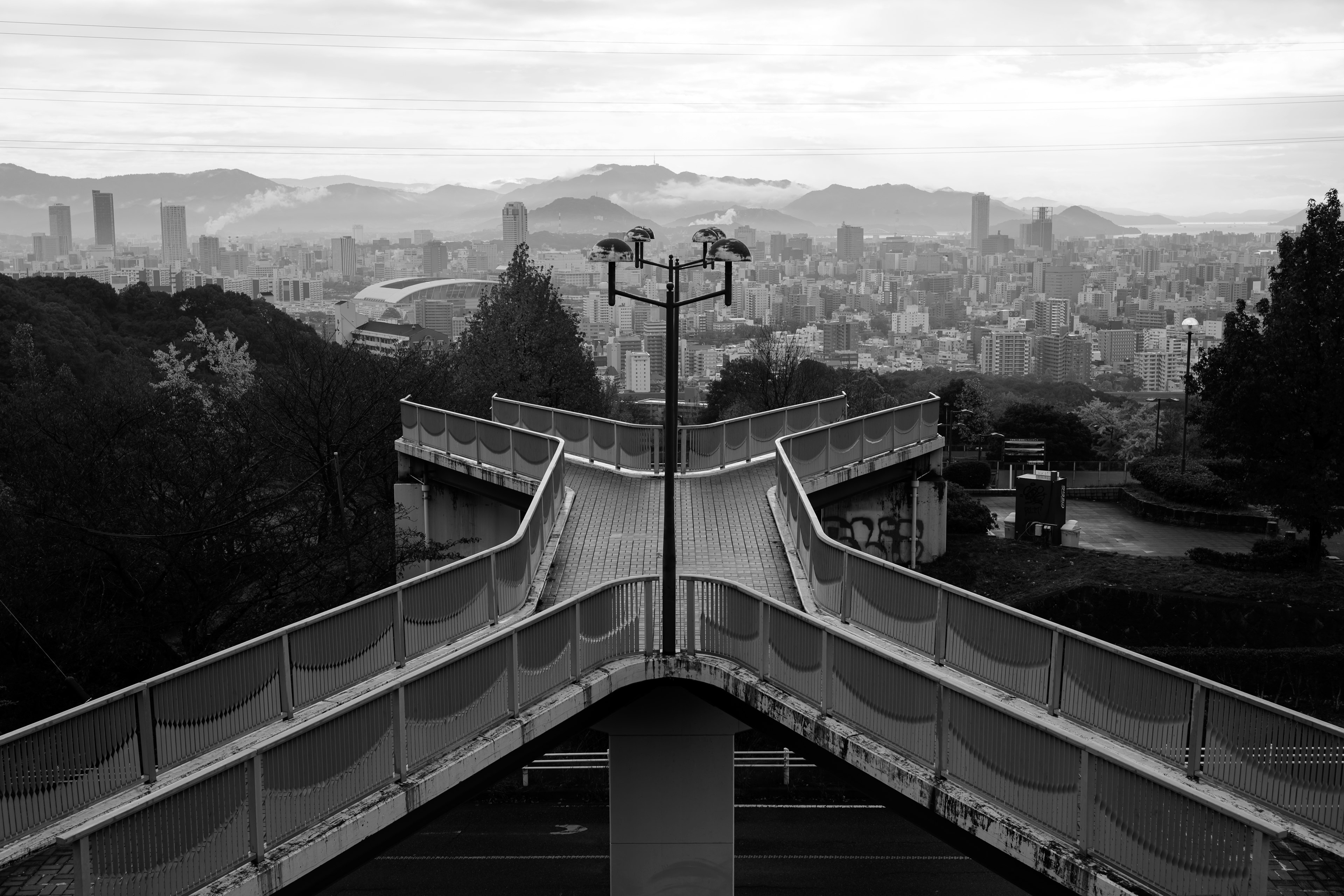 Monochrome viewpoint of an intersection overlooking a cityscape