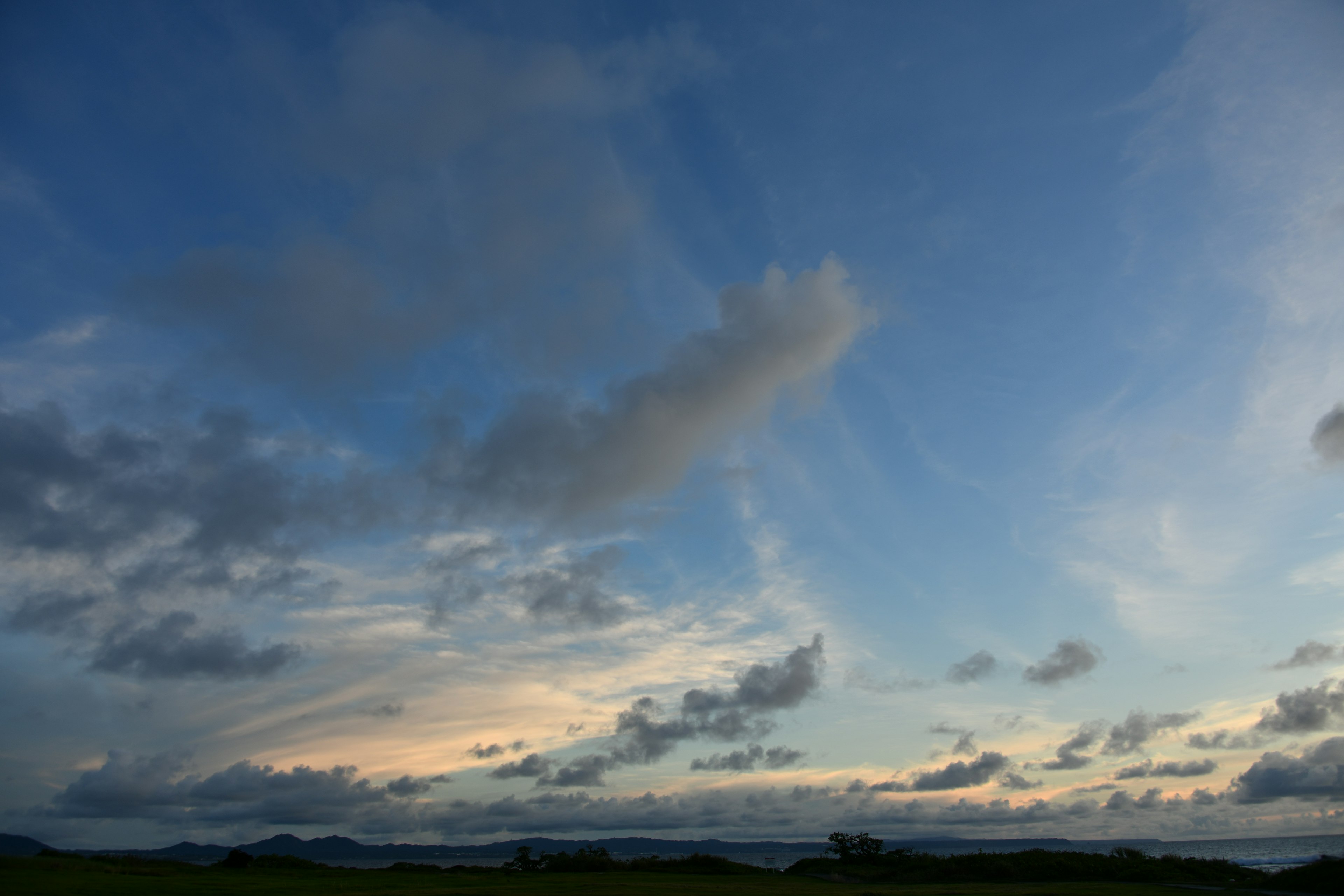 青空に白い雲が広がる風景夕焼けの光が差し込む