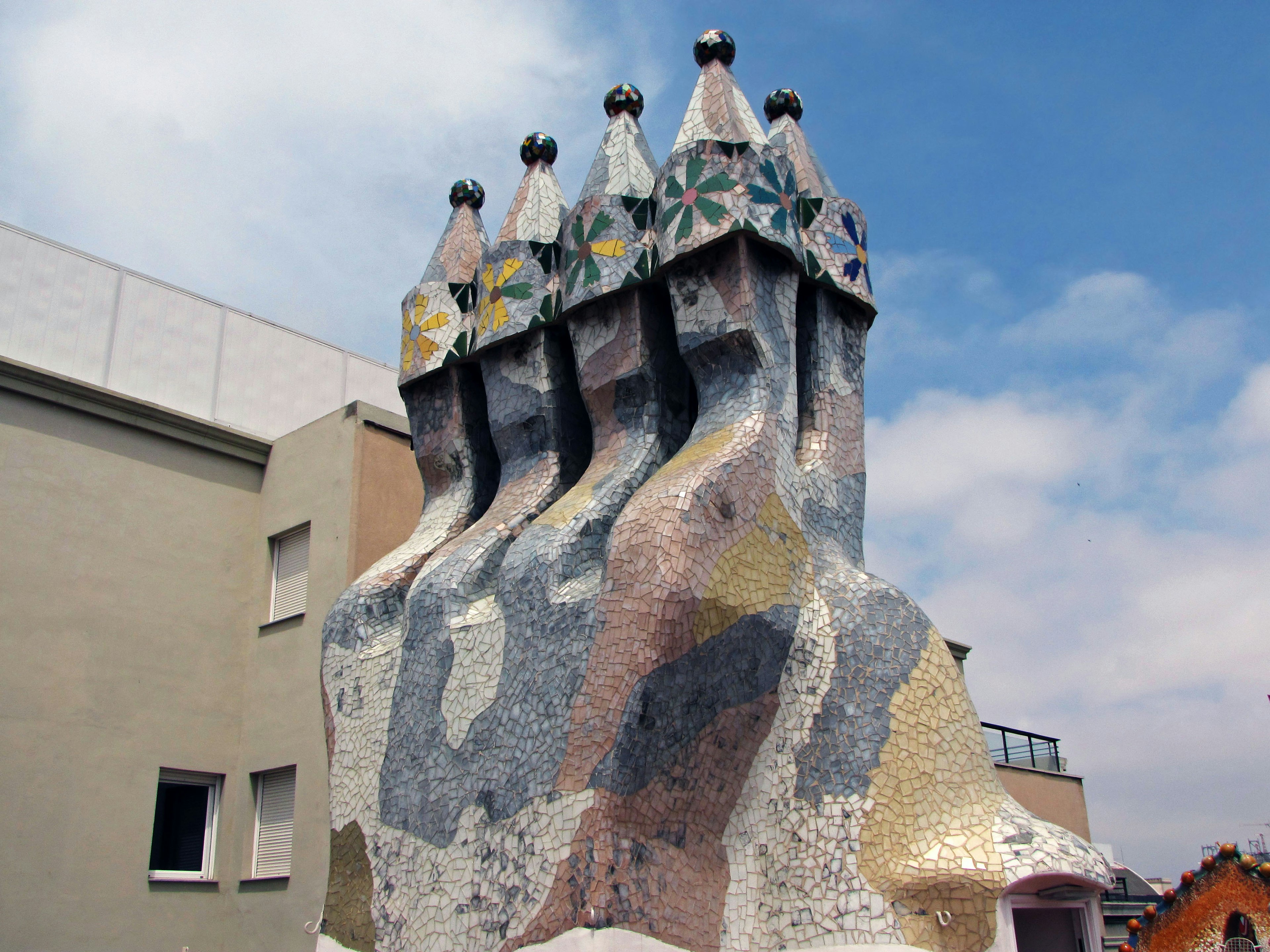 Unique chimney design of Gaudí's Casa Milà featuring colorful mosaic tiles