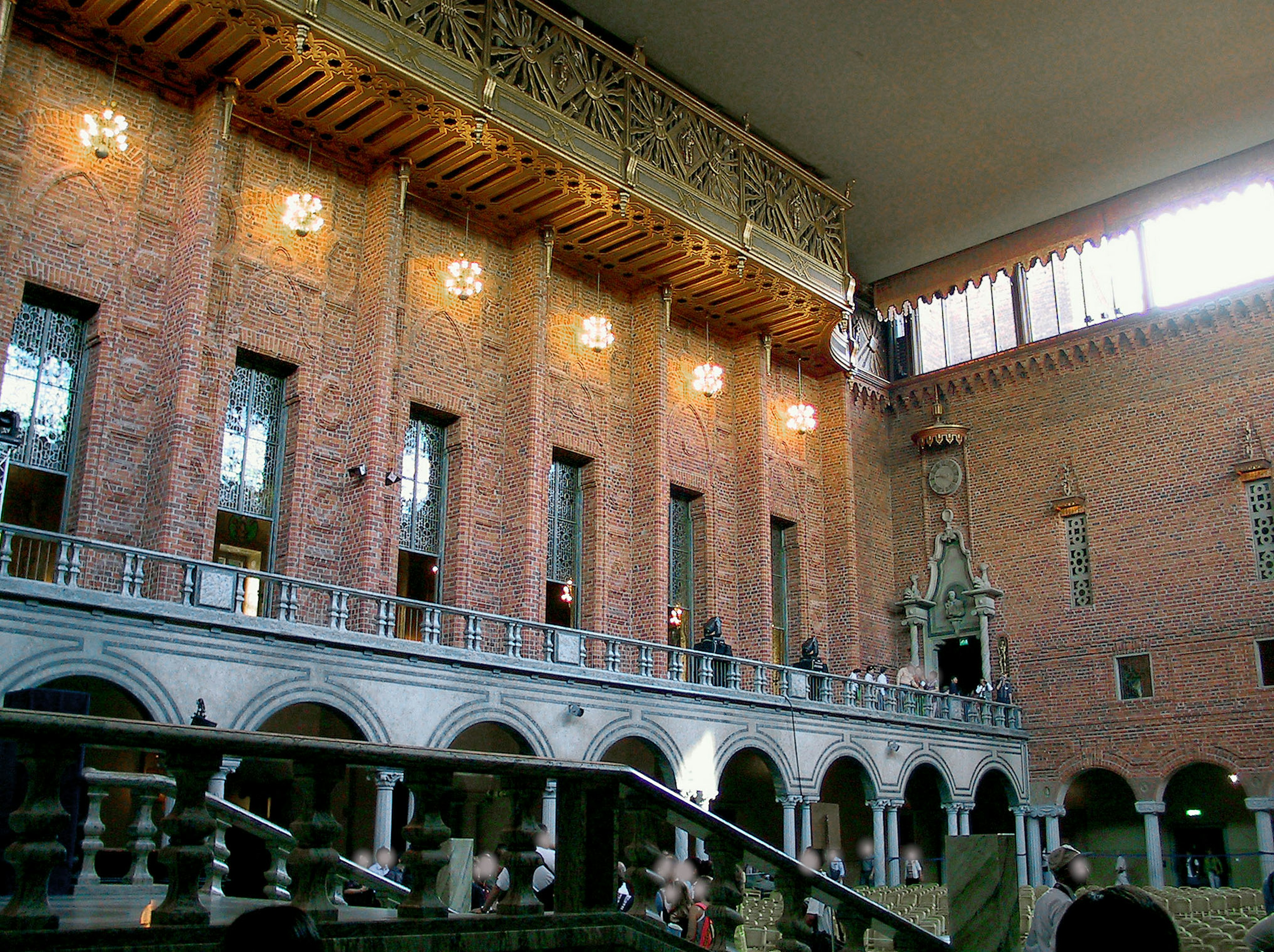 Interior of Stockholm City Hall featuring beautiful red brick walls and arched windows