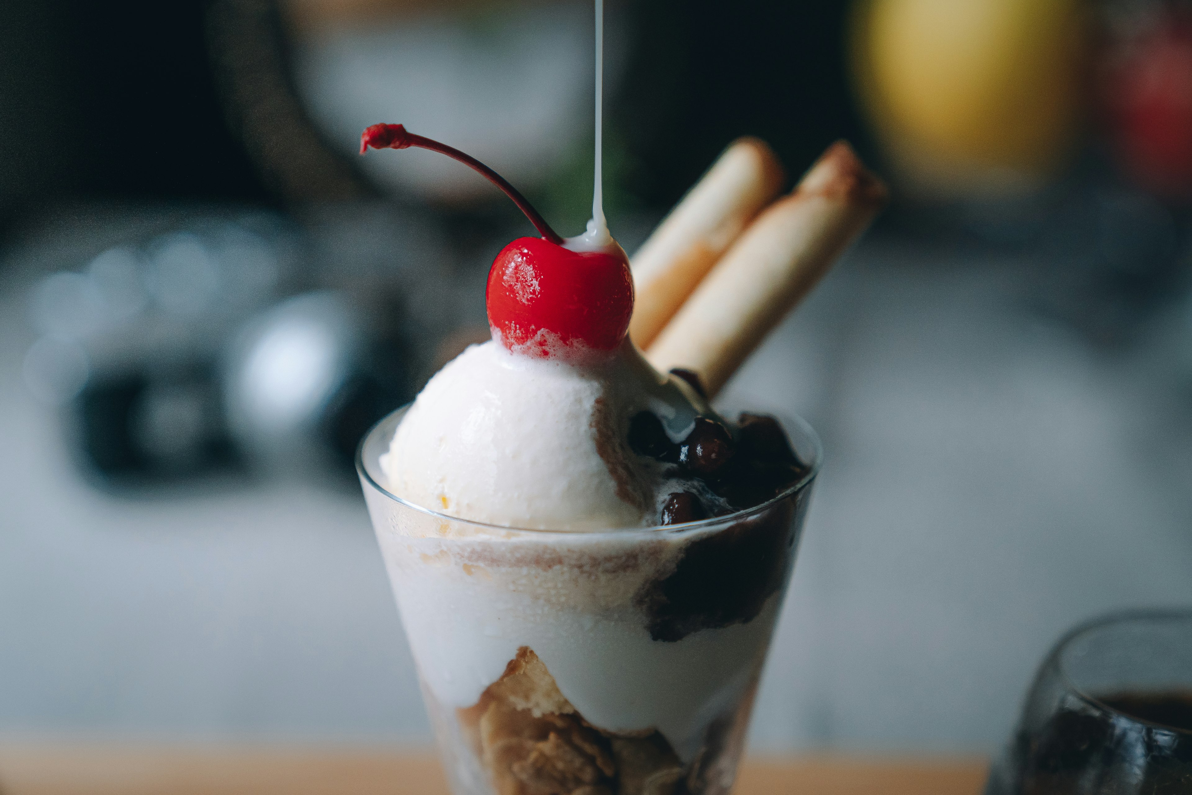 Ice cream parfait topped with cherry and cookies