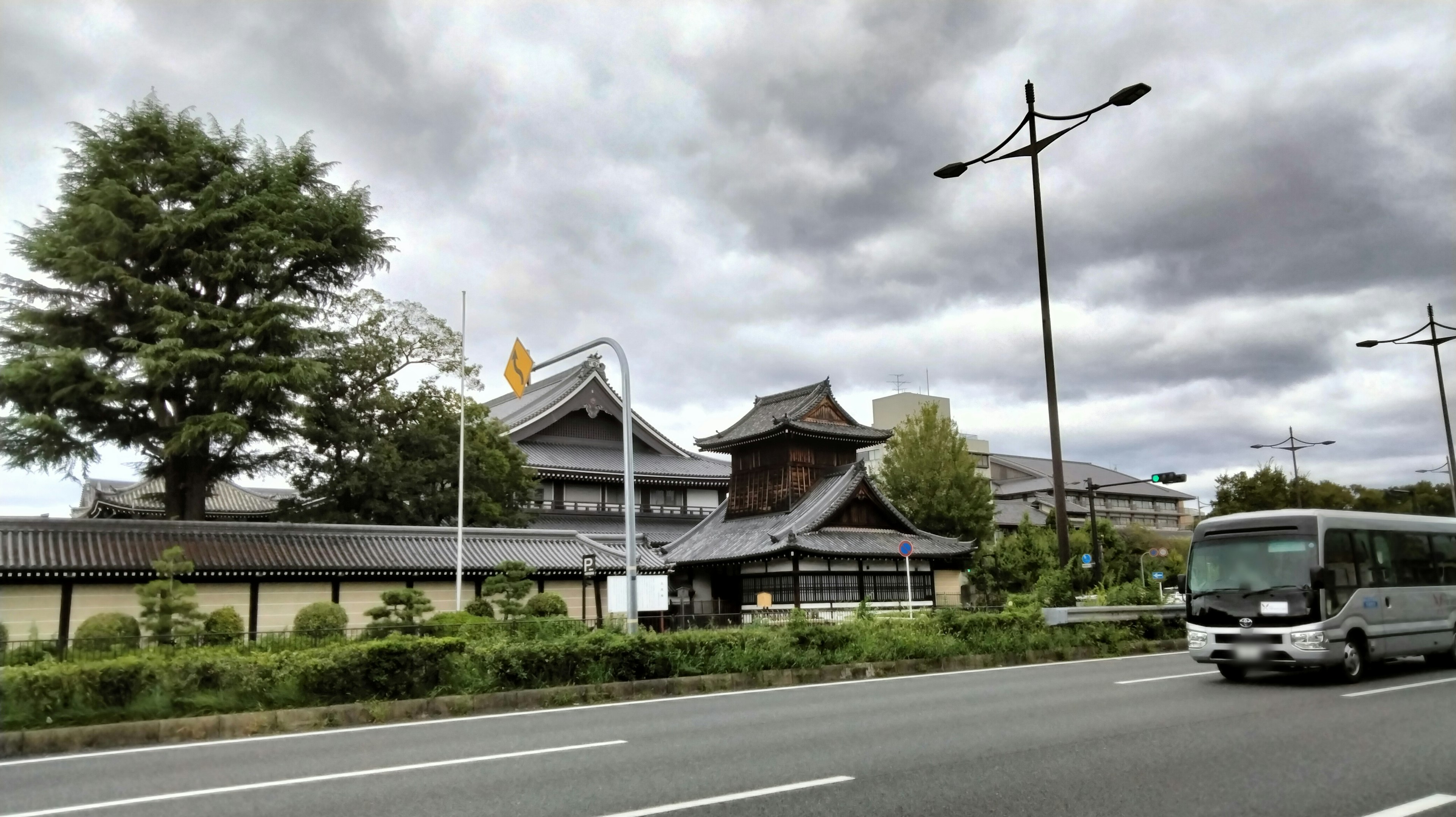 Traditional Japanese building along the roadside with a bus