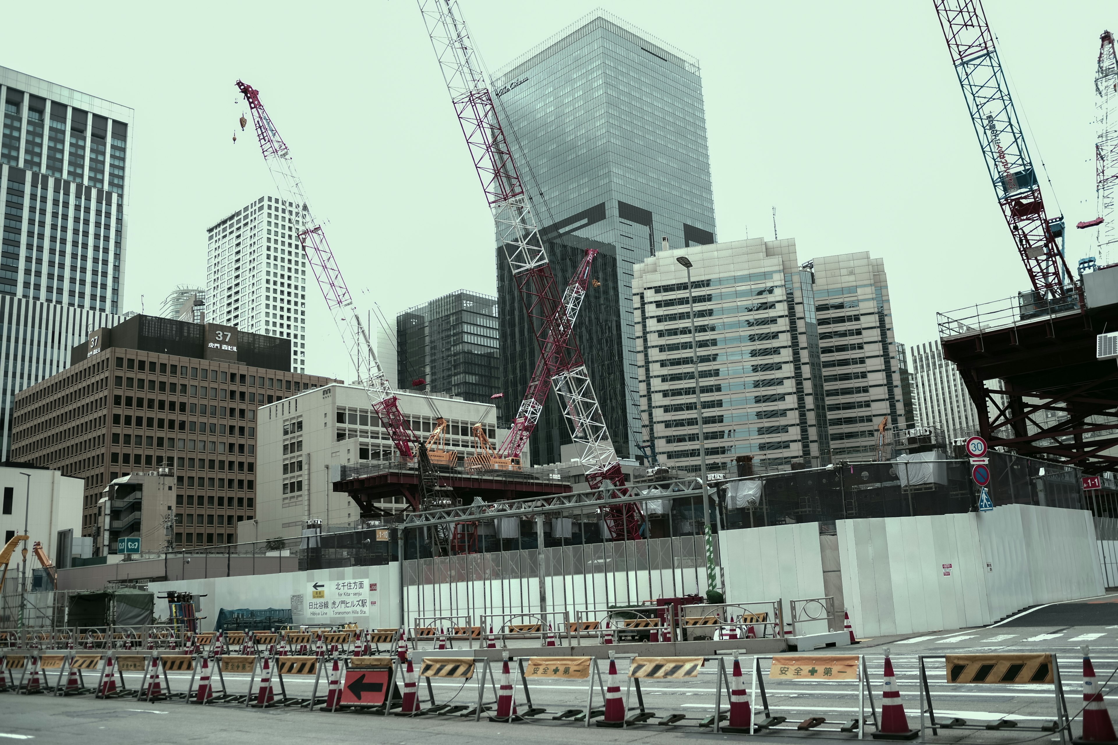 Construction site featuring cranes and skyscrapers