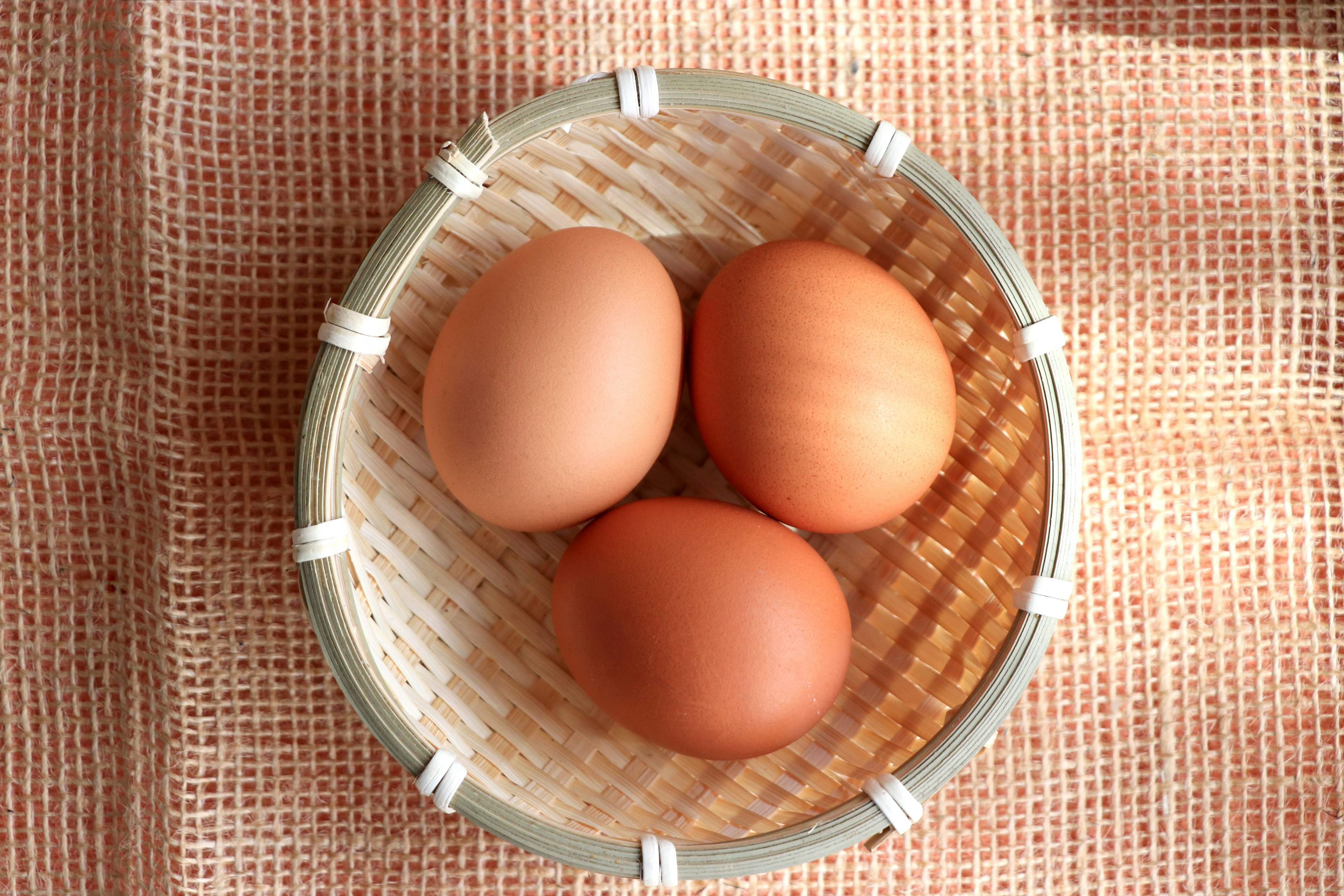 Three eggs in a woven basket