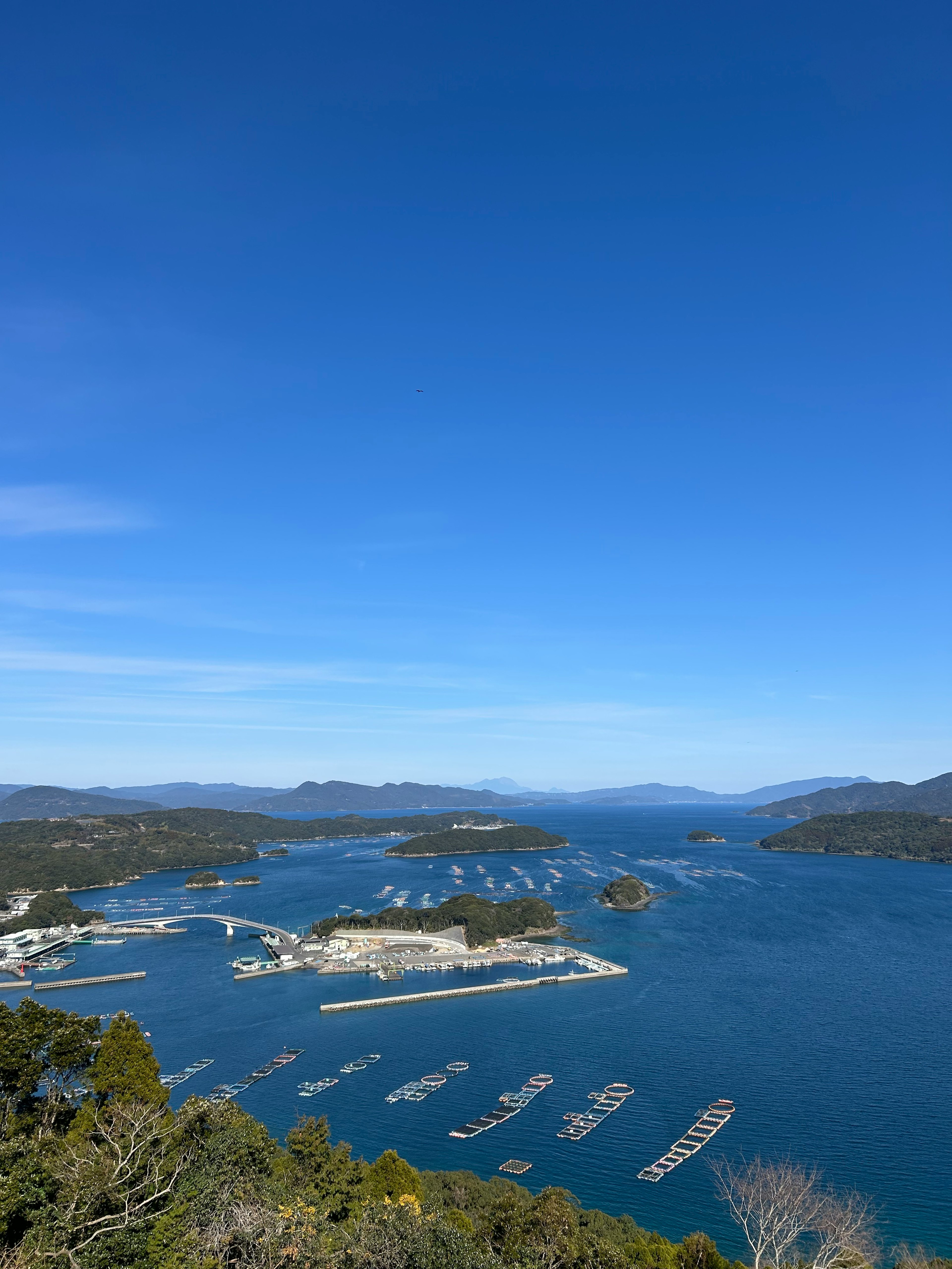 Scenic view of islands and sea under clear blue sky