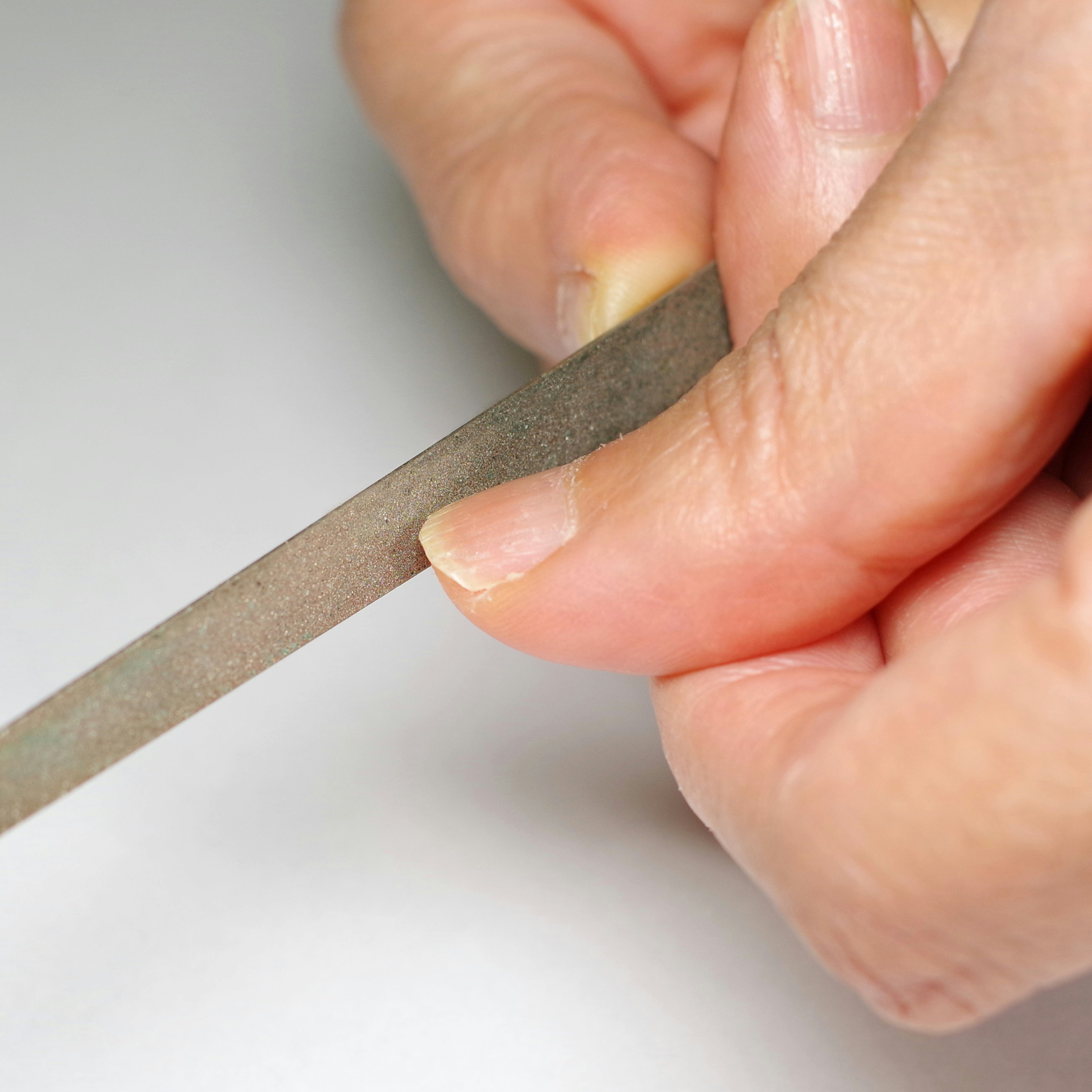 Close-up of a hand holding a nail file