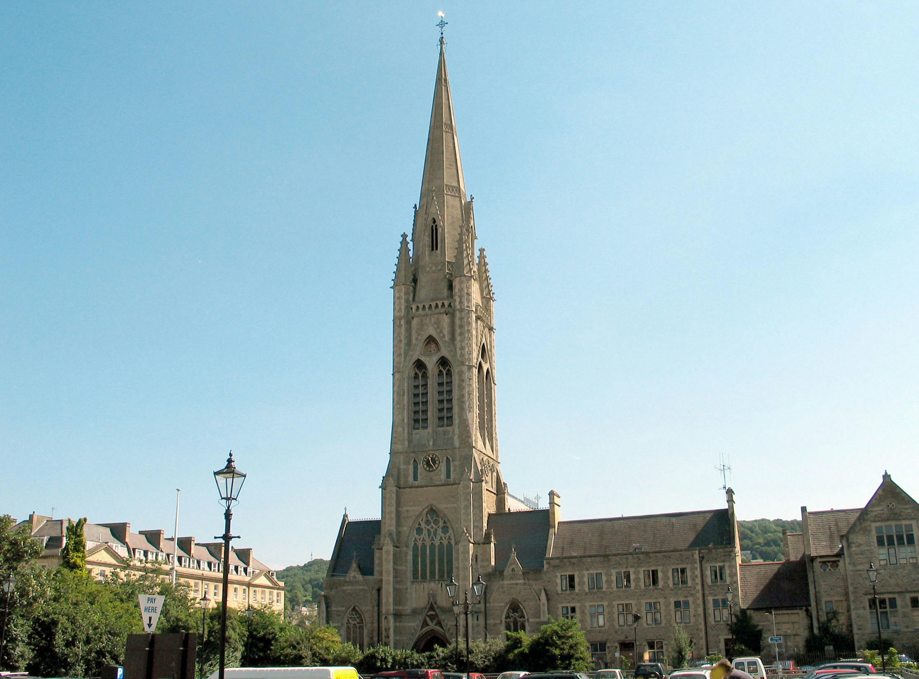 Gothic-style church tower rising under a clear blue sky