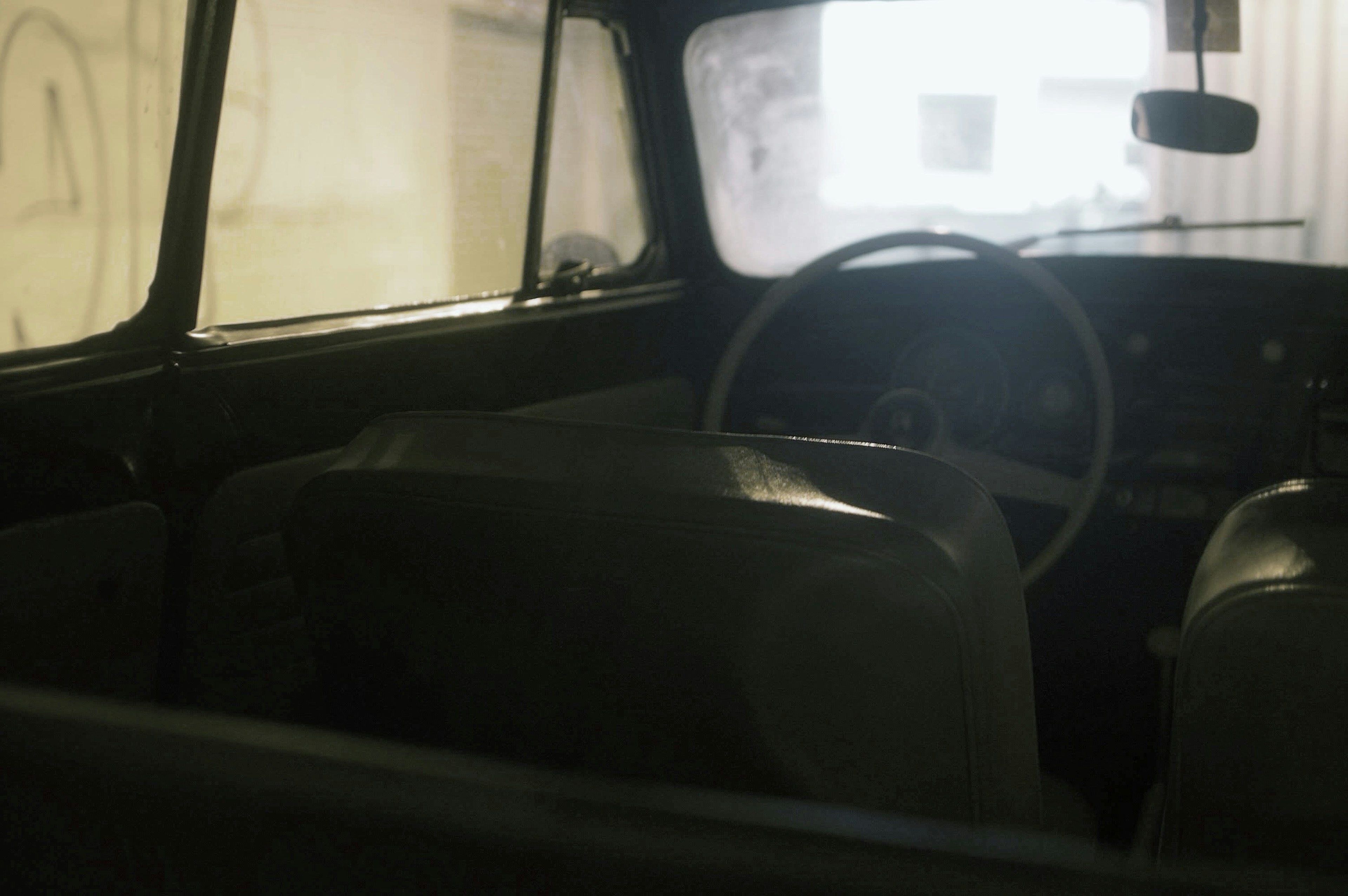 Interior view of a vintage car with a steering wheel