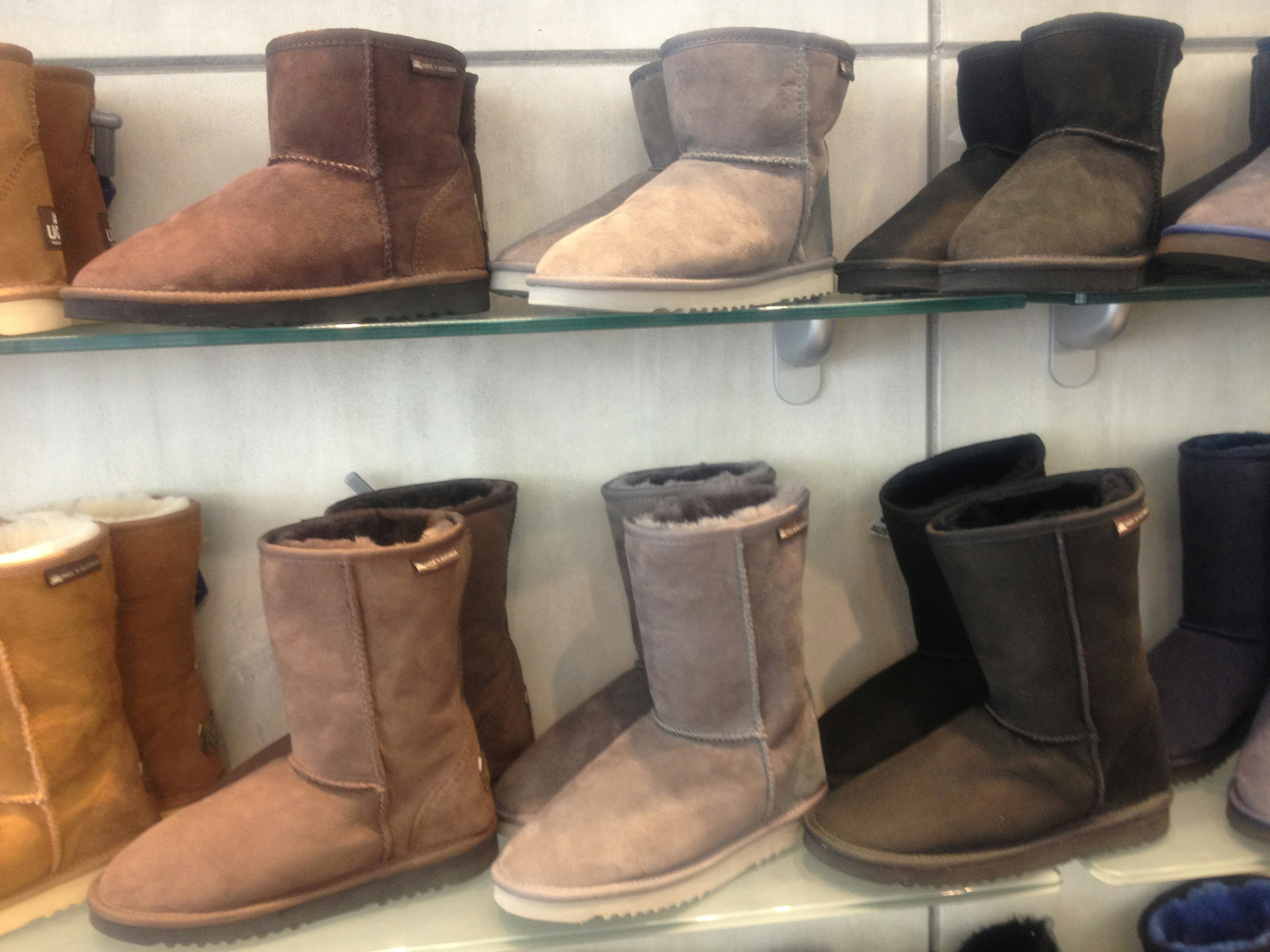 Various colored boots displayed on a shelf