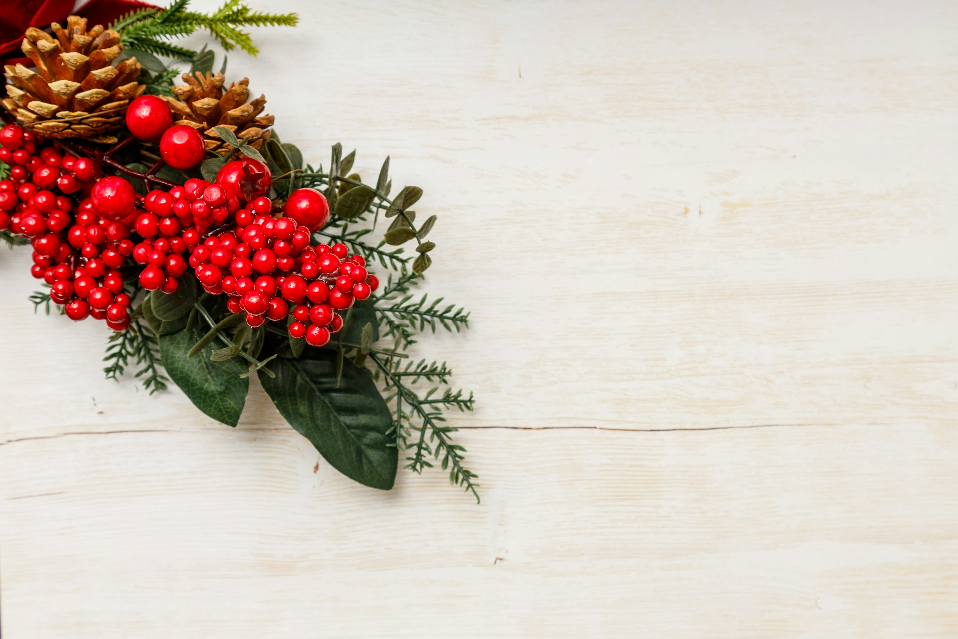 Christmas arrangement featuring red berries and pine cones