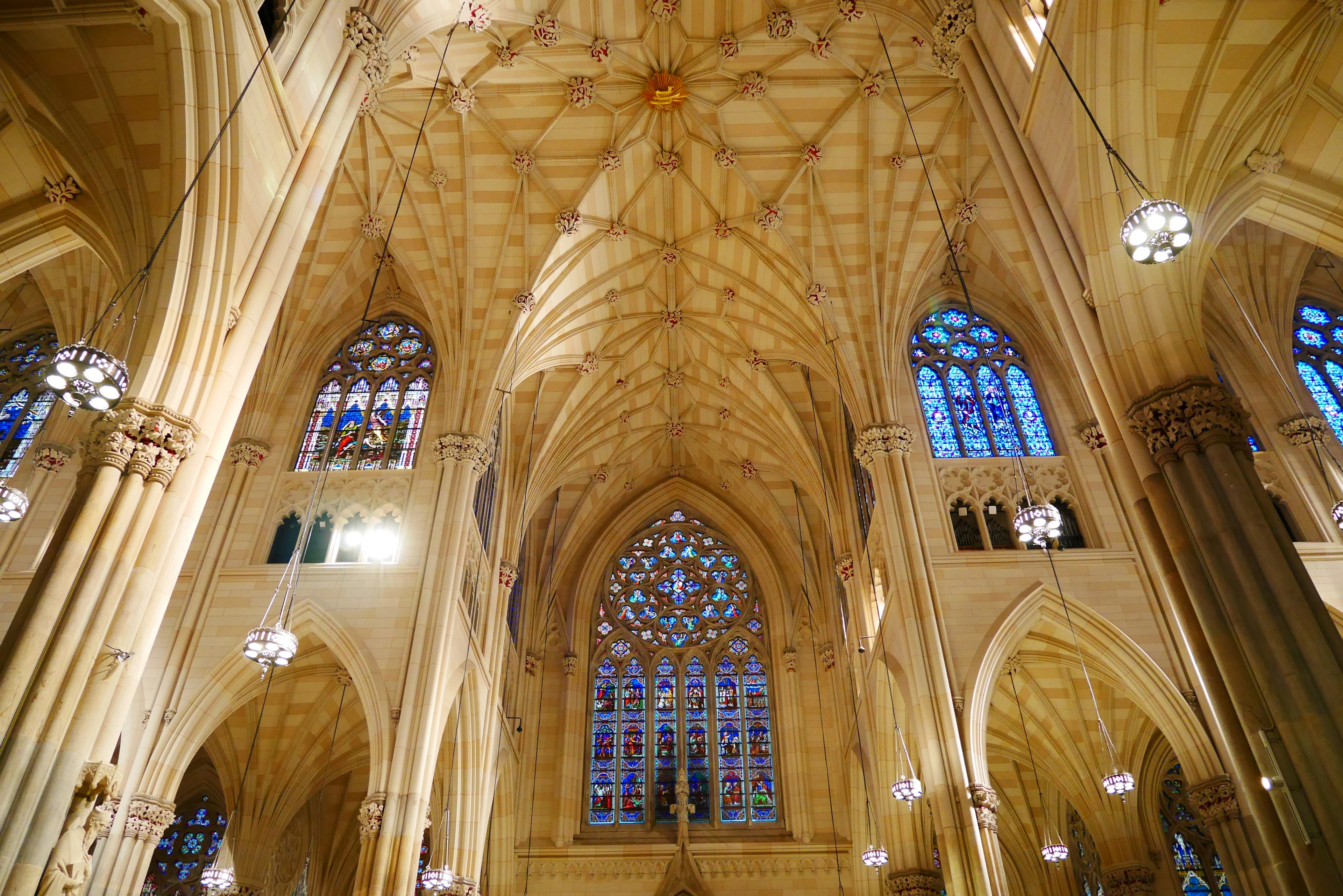 Beautiful vaulted ceiling and stained glass windows of a church interior