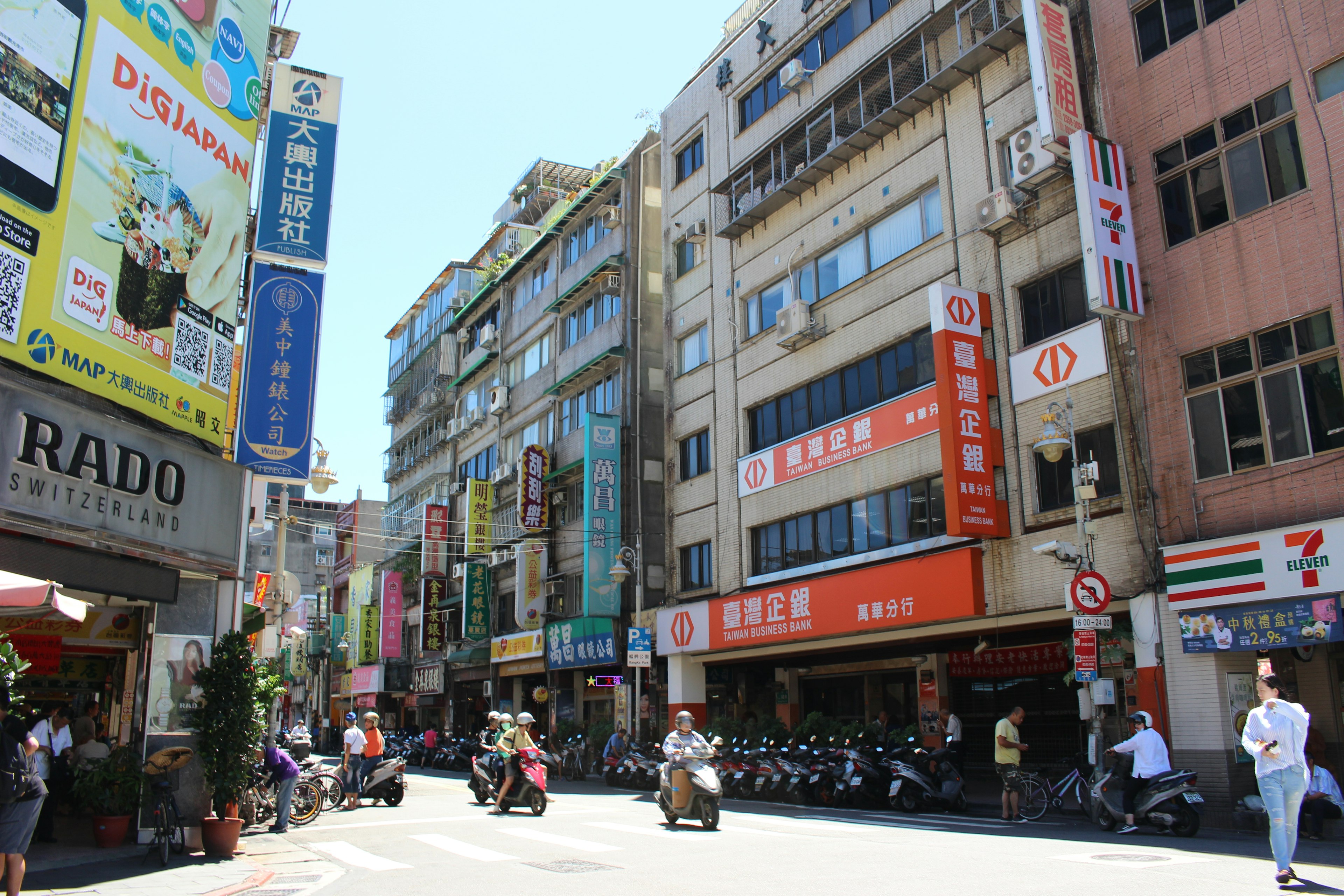 Bustling street scene with storefronts and colorful signs