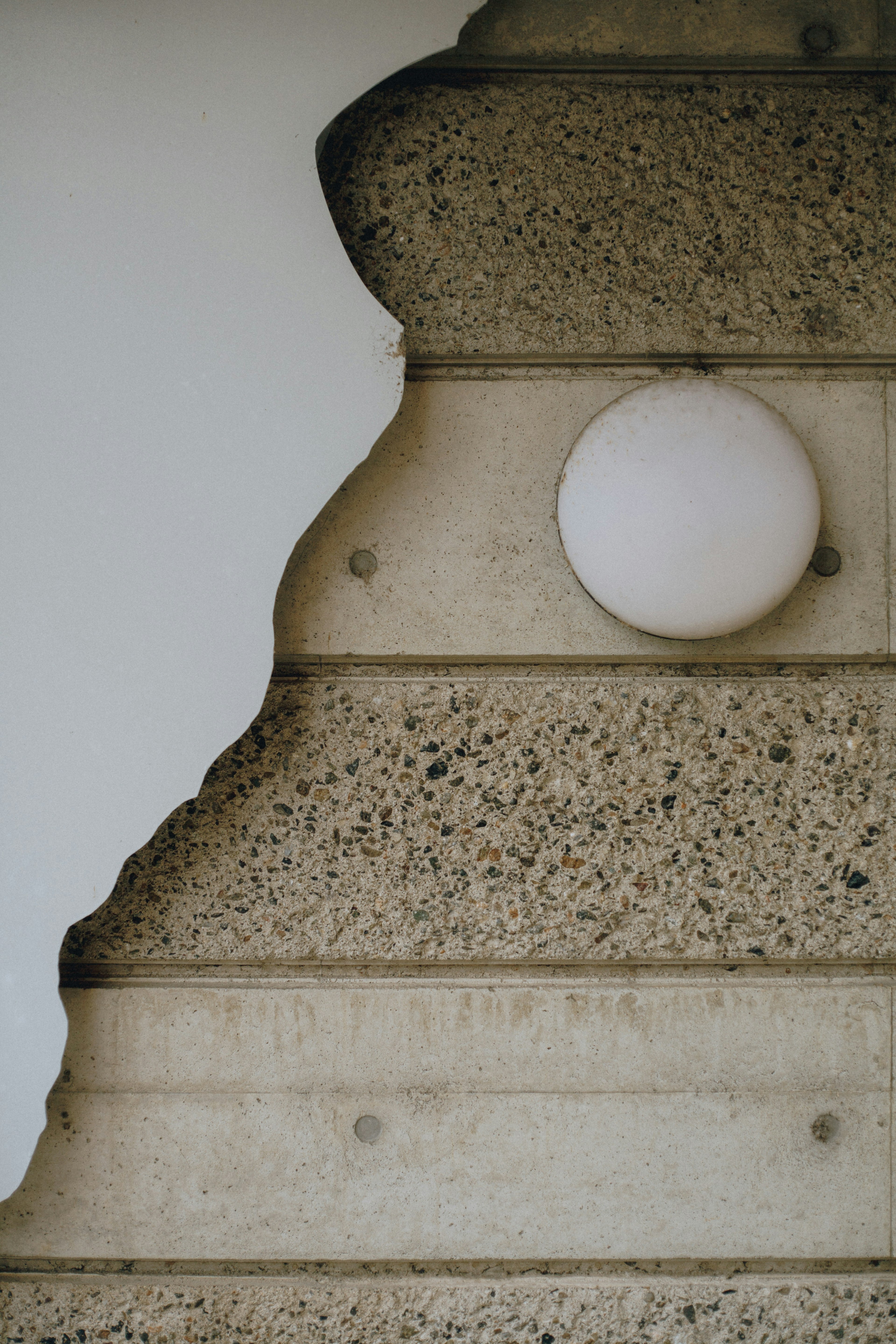 Part of a wall with a peeling design and a white spherical decoration