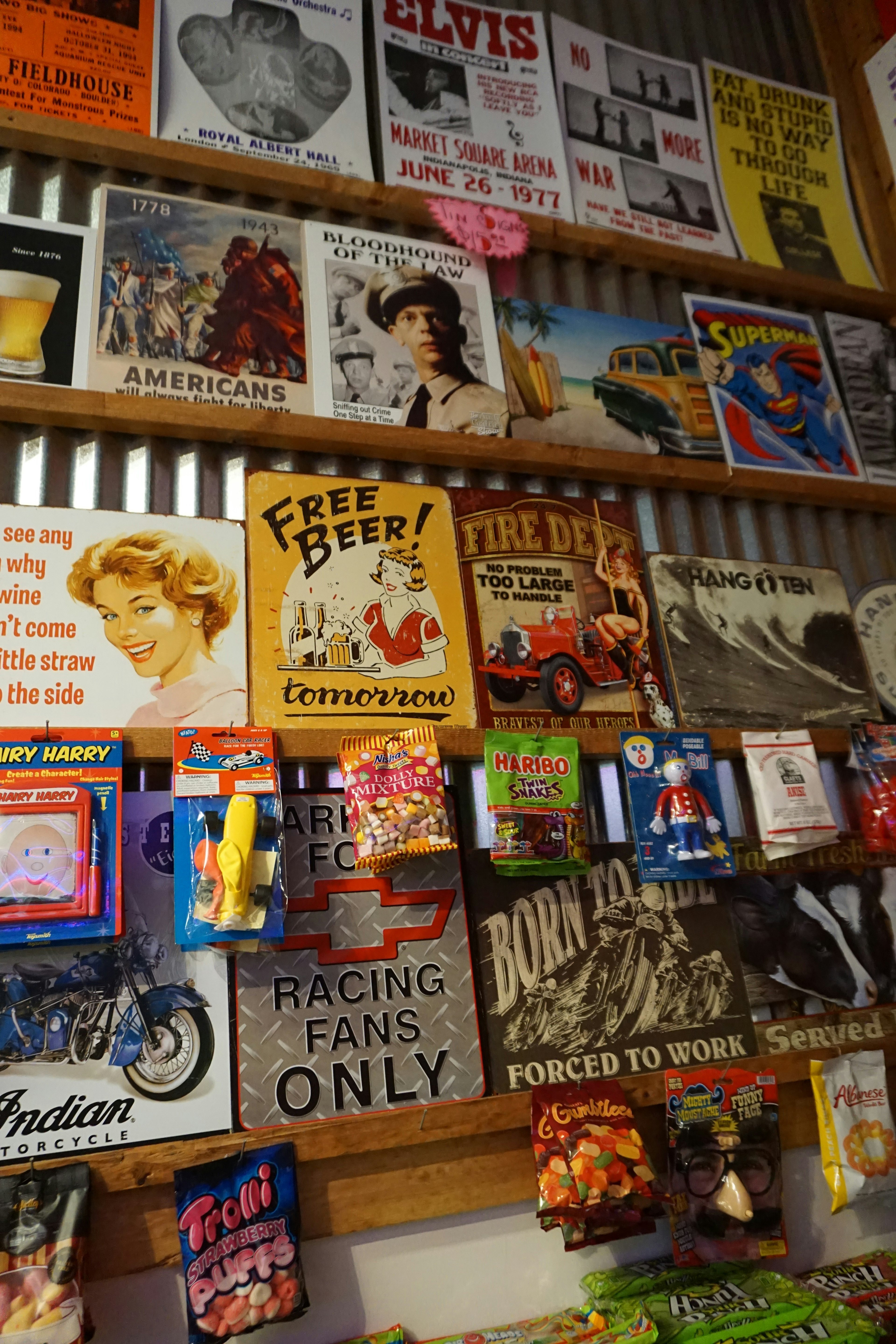 Collection of vintage posters and signs displayed on a wall