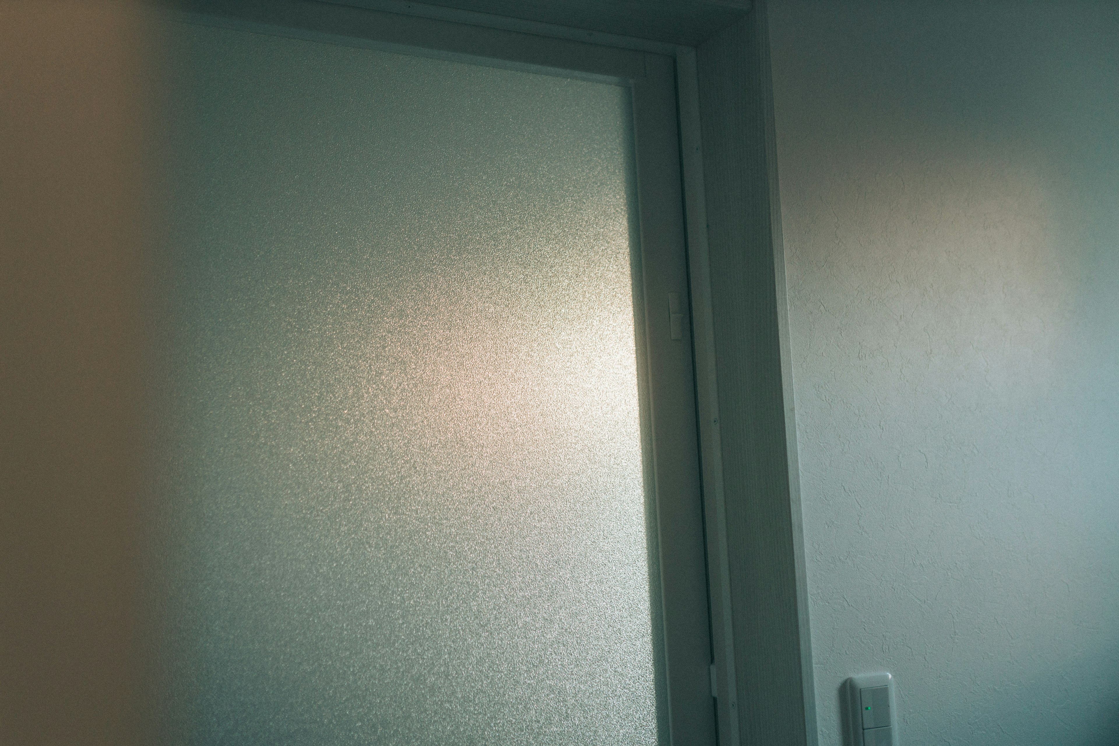 Frosted glass door with soft light filtering through