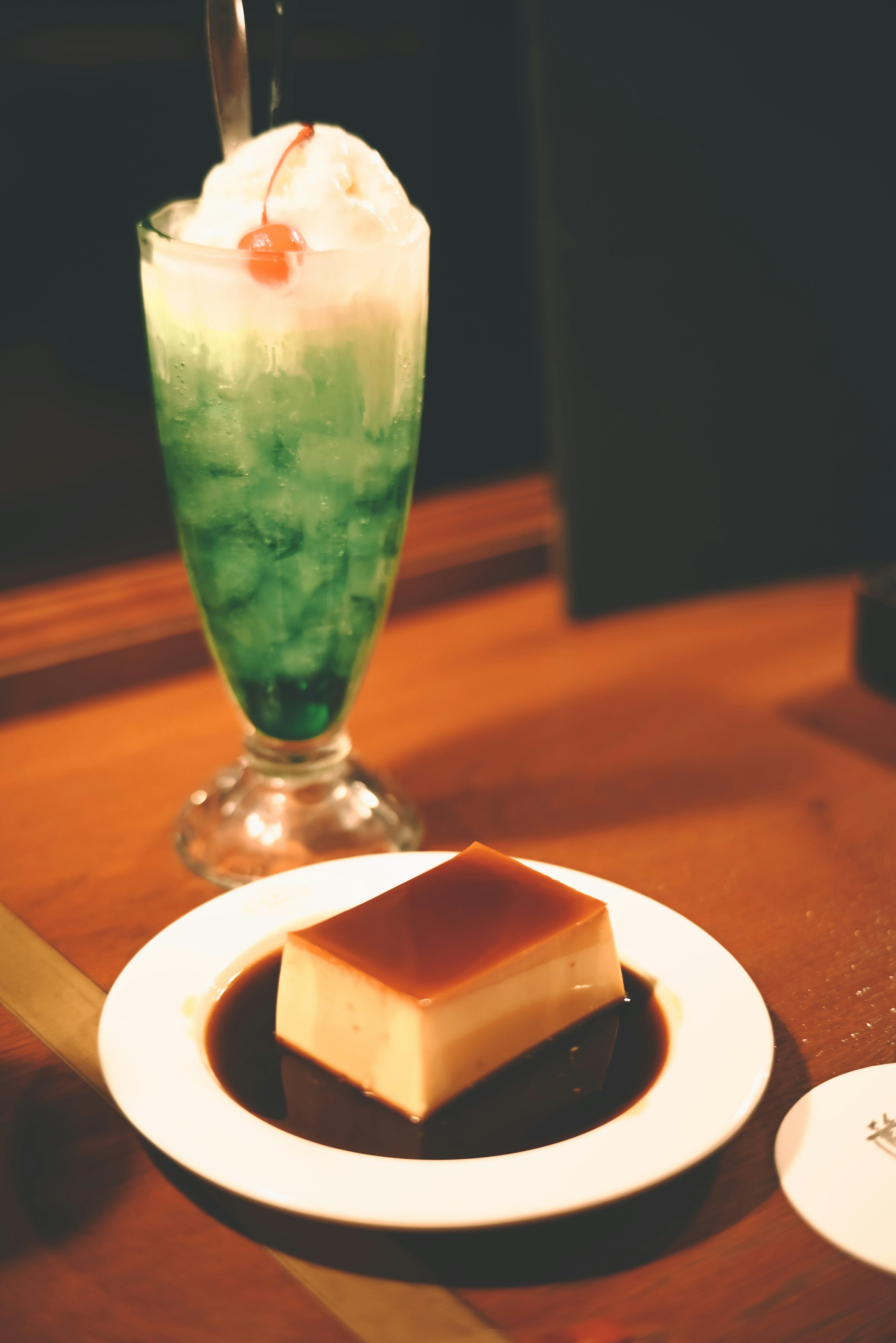 Green beverage with cream topping and dessert