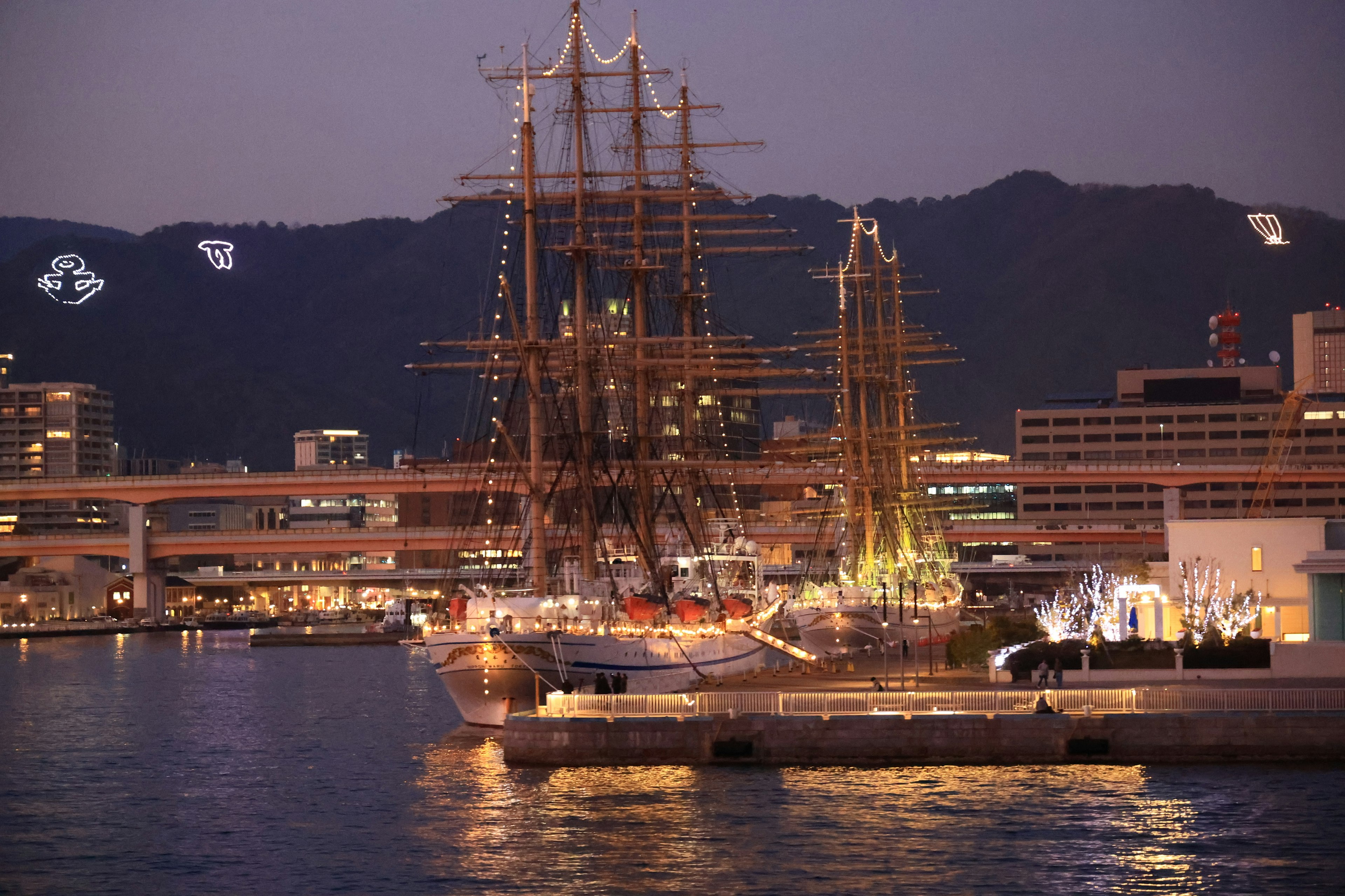 Beautiful tall ship docked at the harbor with night lights