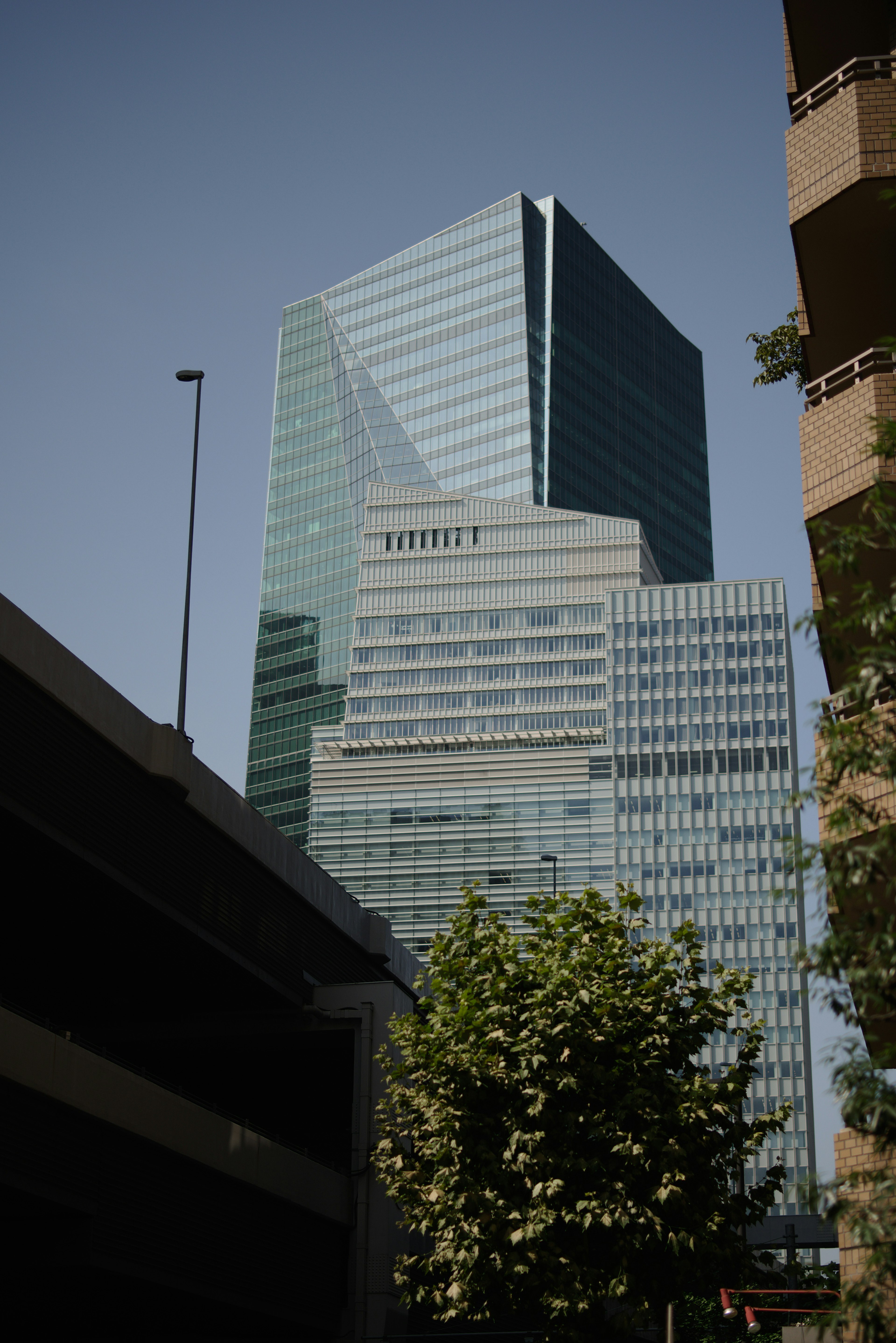 Urban landscape featuring skyscrapers with glass facades and greenery