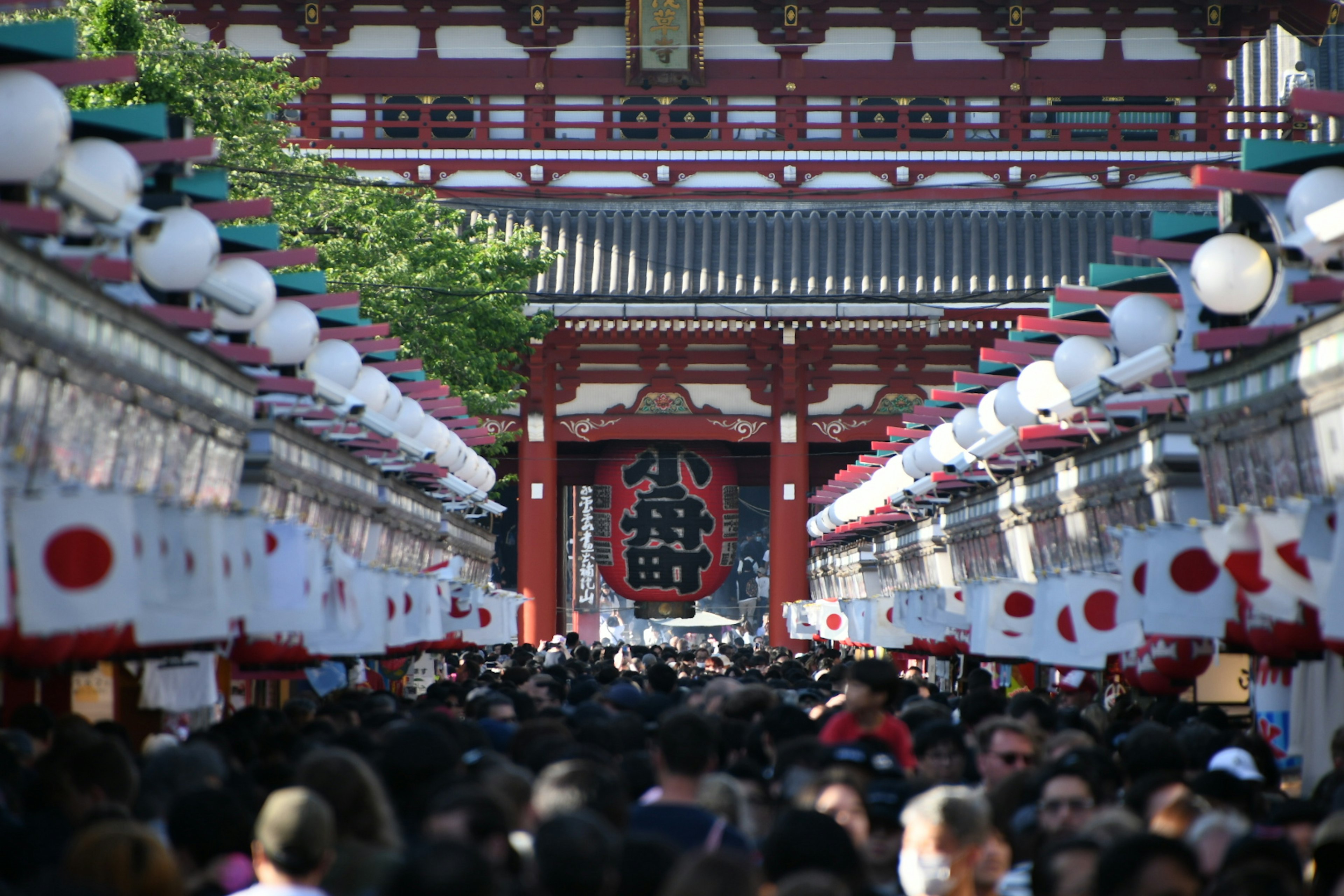 浅草寺の門前に集まる人々と提灯が並ぶ賑やかな通り