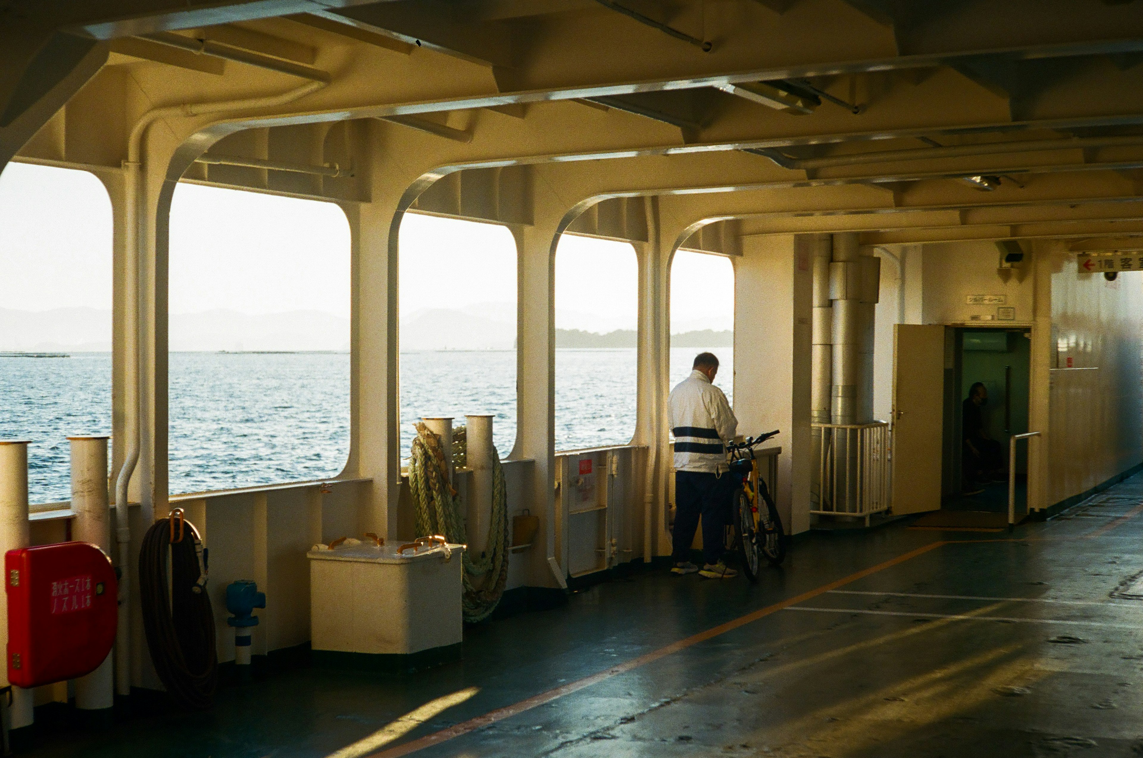 Worker gazing at the sea from the deck of a ship