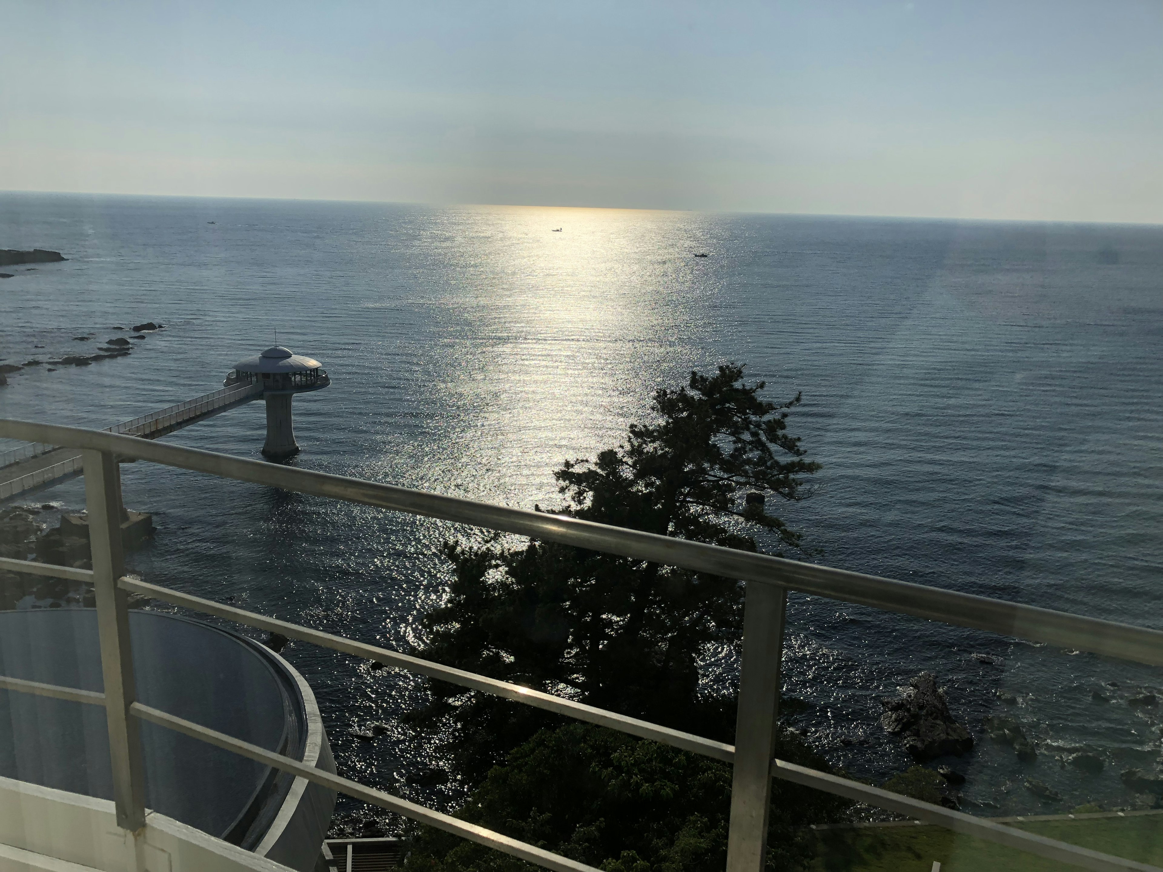 Scenic view of the ocean from a balcony with a railing