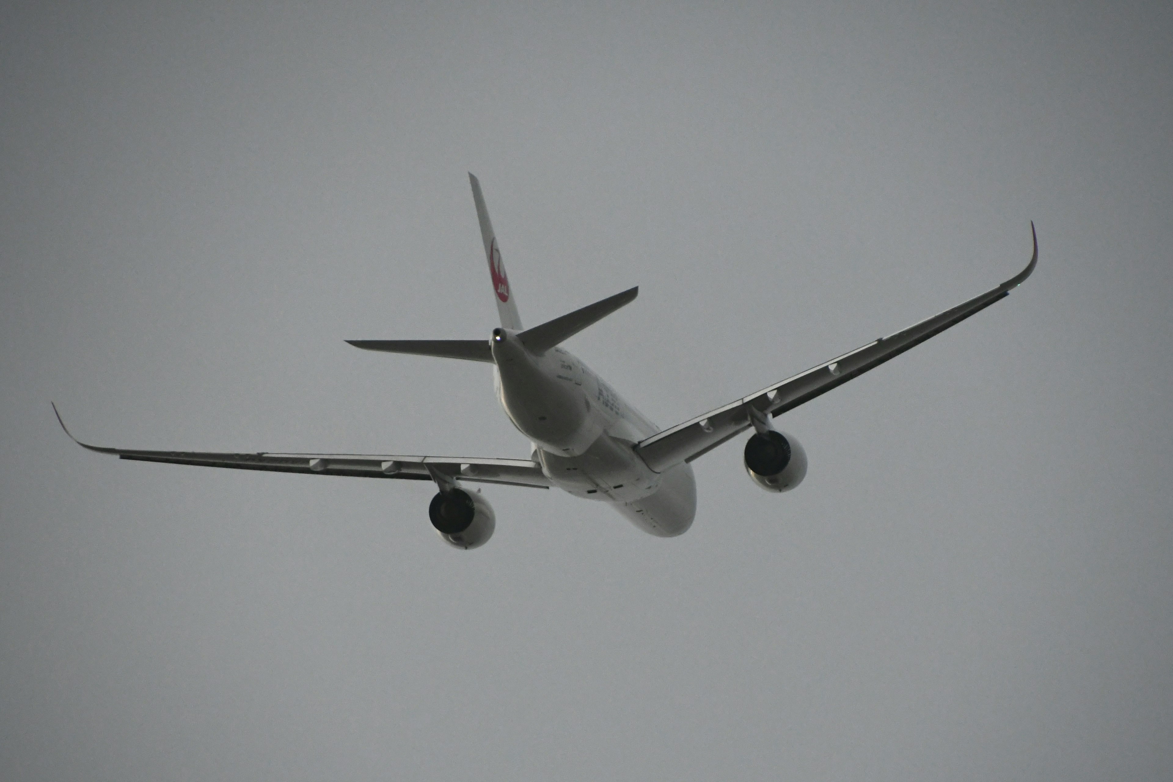 Airplane flying in the clouds from below